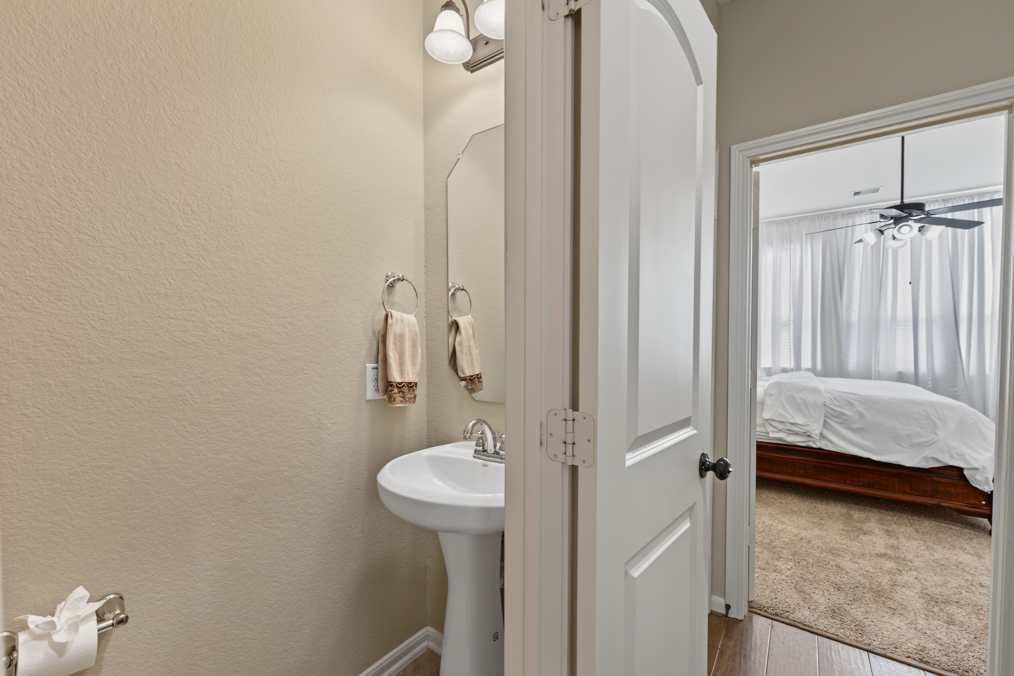 Conveniently designed  1/2 bathroom for your guests with a pedestal sink and mirror just off of the upstairs living area.
