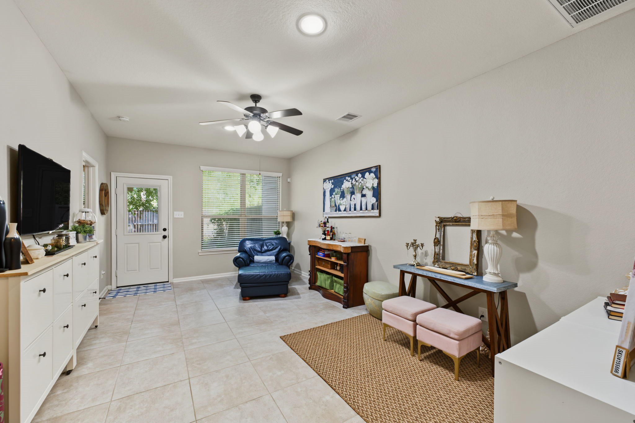 Enjoy the downstairs living room, complete with neutral flooring, a ceiling fan, and a layout ready for everyday living.