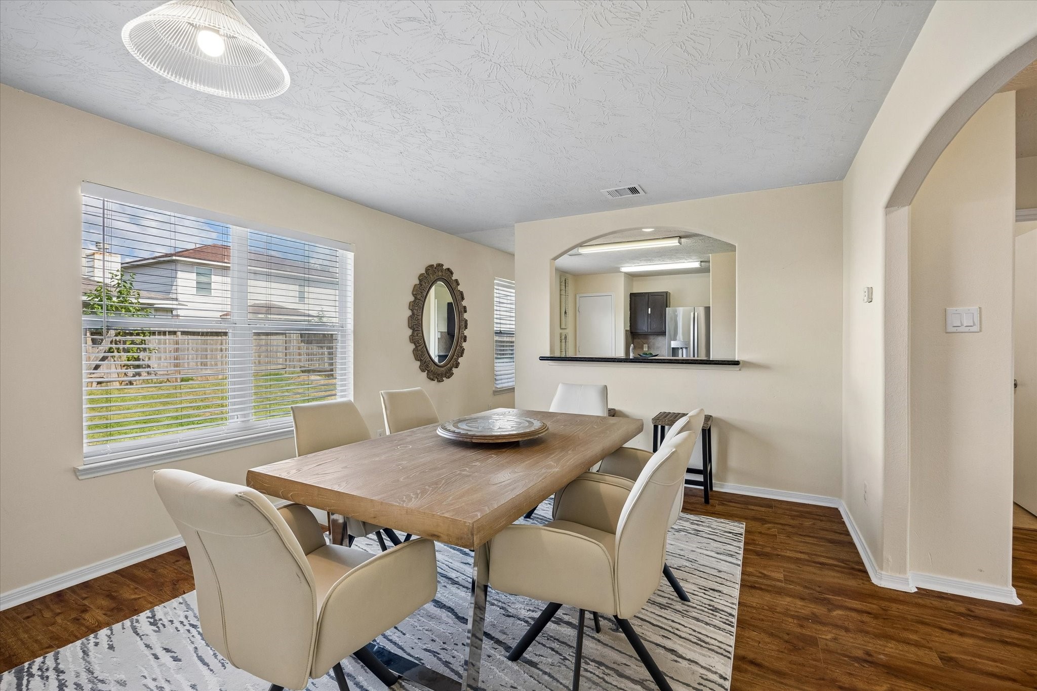 Bright and inviting dining area, with large windows, modern lighting, and an open layout perfect for family gatherings