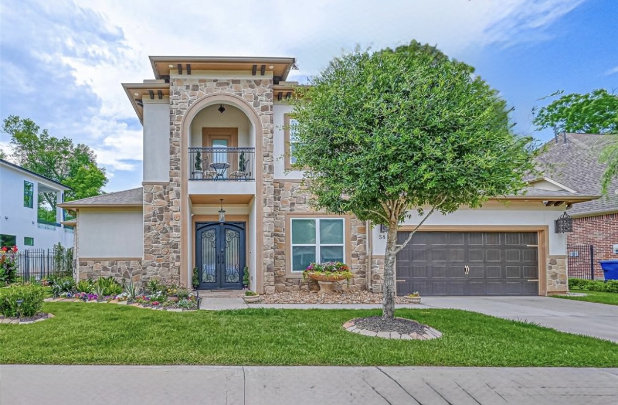 A fine stucco and stone esthetic, with balcony. This home is luxurious both inside and out.