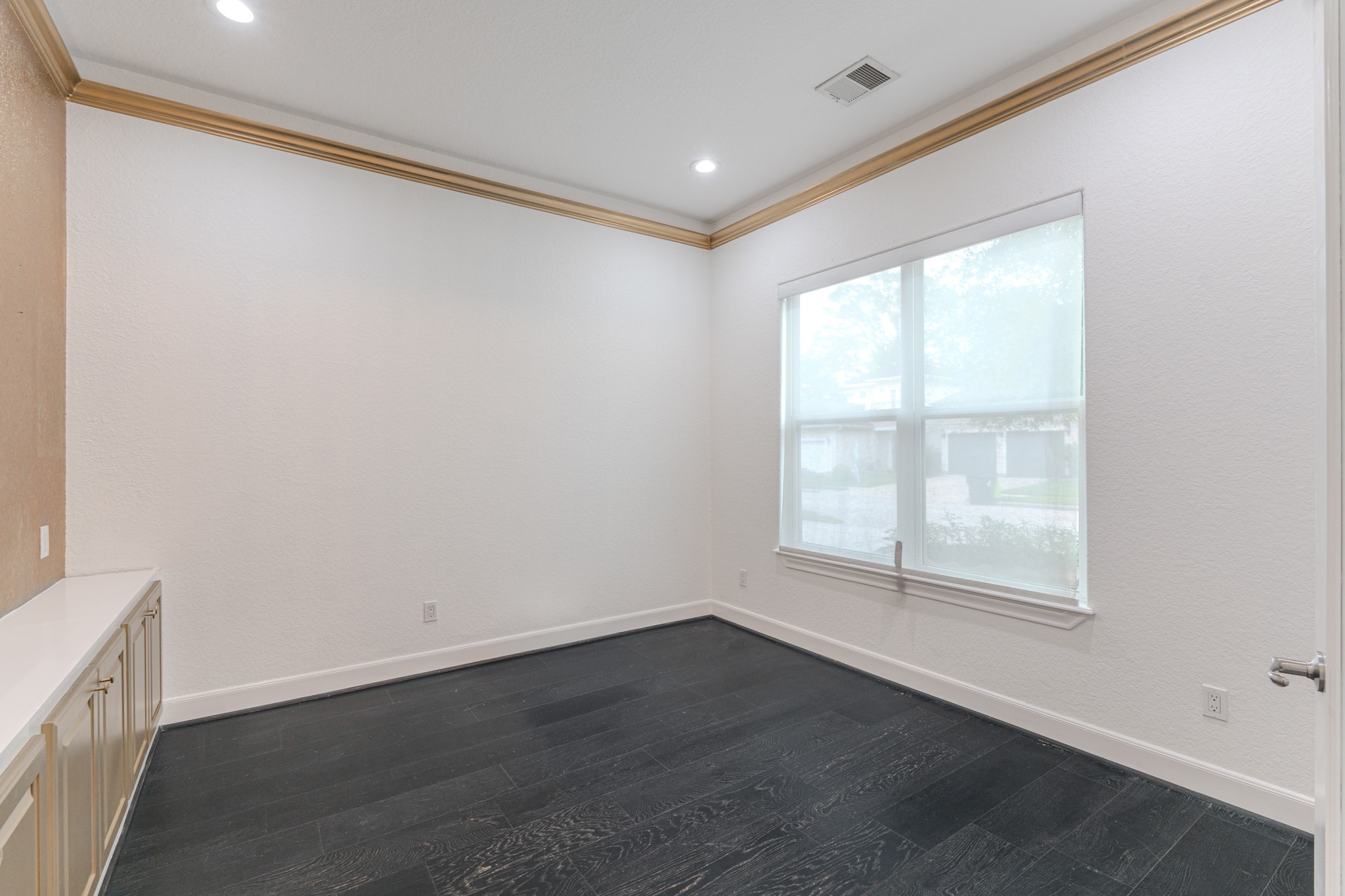 Study or home office, engineered wood, counter space with built-in cabinetry, electic shades, crown molding, french doors.