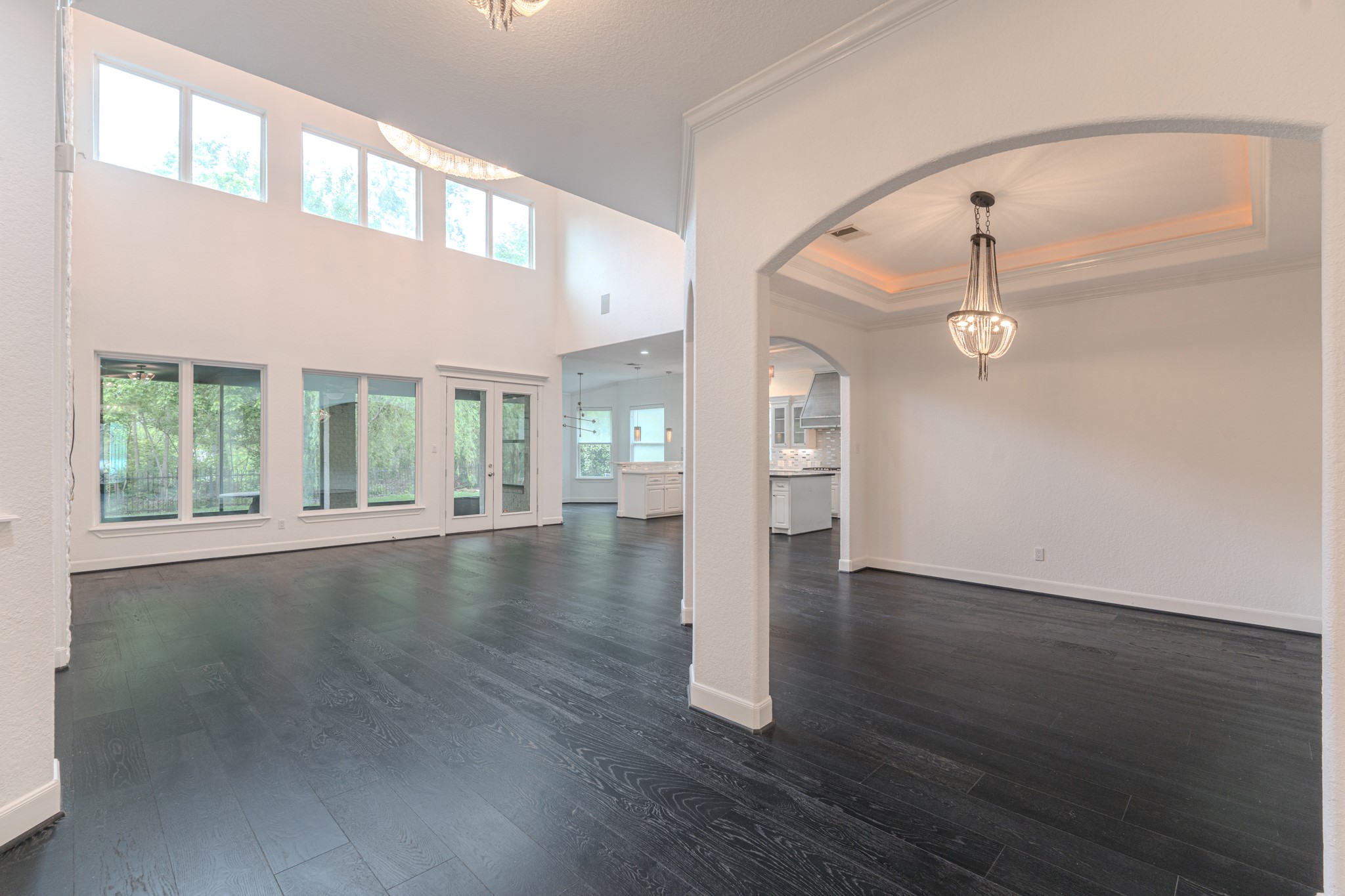 Open living with soaring 2 story ceilings, Formal dinning room with tray ceilings and cove lighting detail.