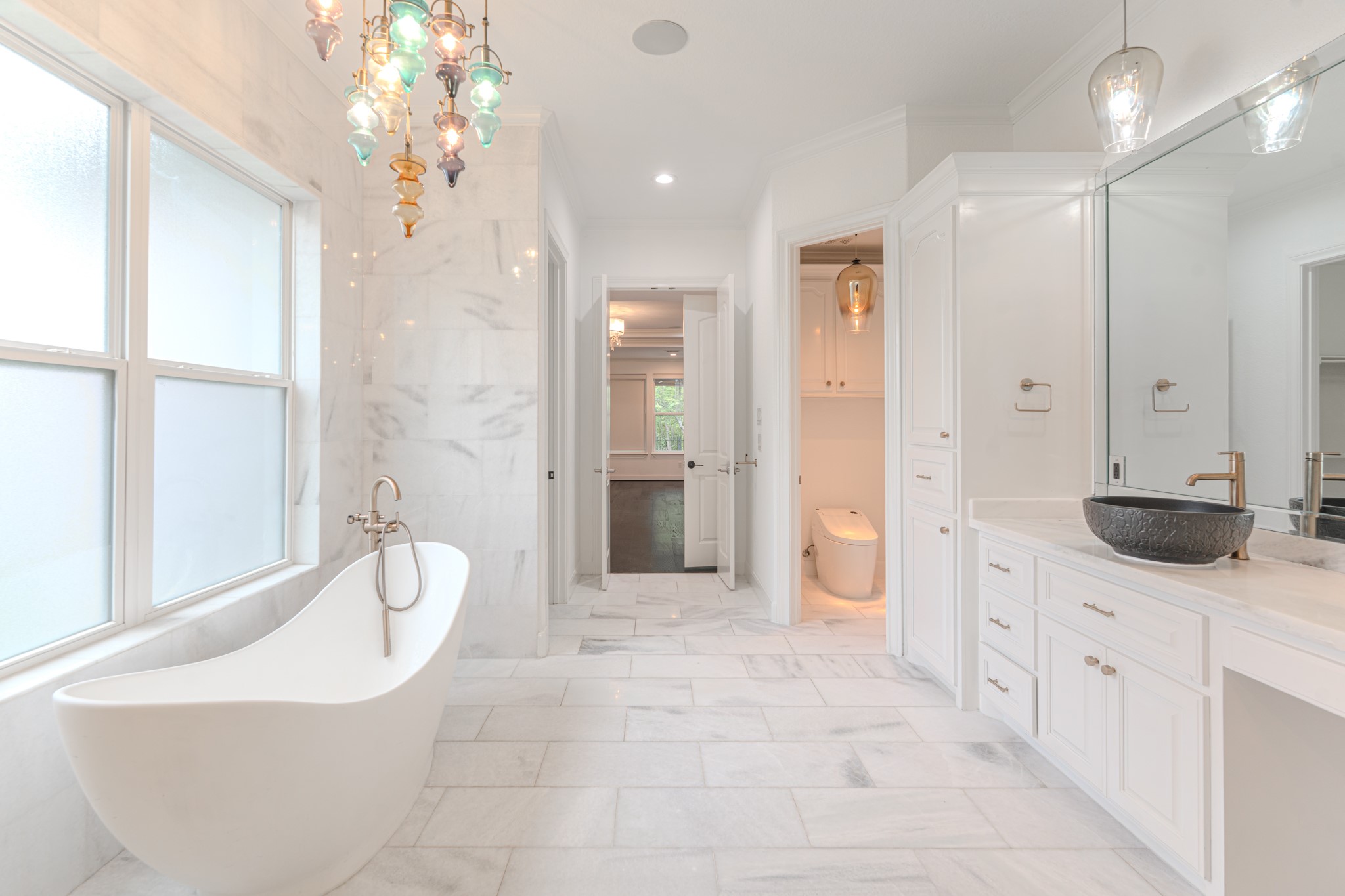 Absolutely beautiful spa like bath with soaking tub, marble floors and walls, separate vanity areas. High end finishes throughout.