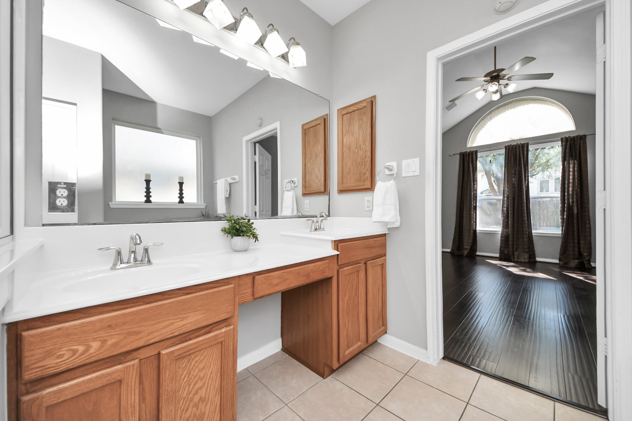 Primary bathroom with dual sinks and vanity area