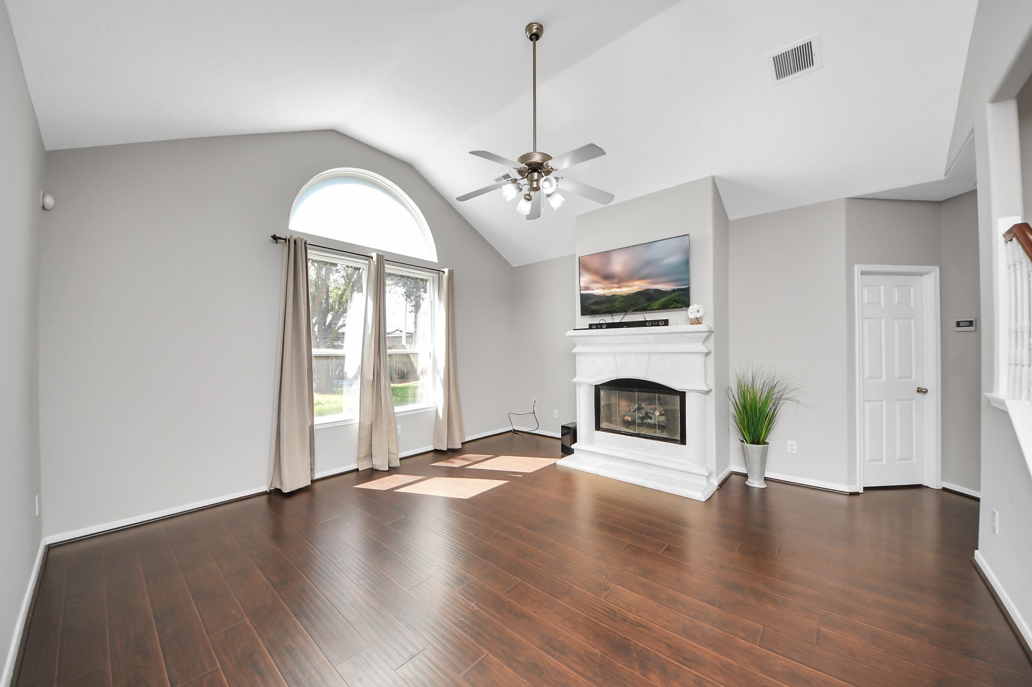 High ceilings featuring a gas fireplace