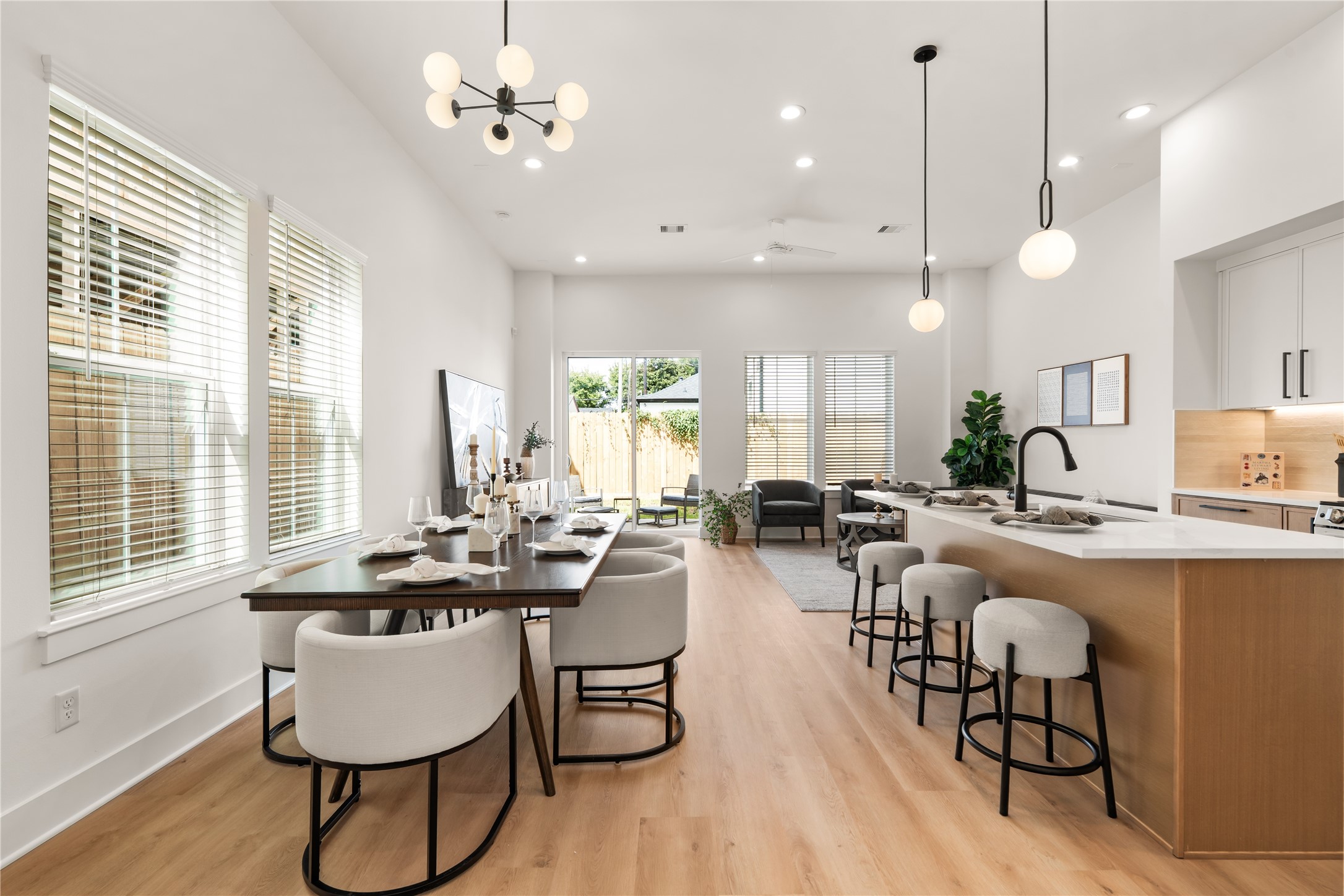 Sunlit open-concept main floor seamlessly connecting dining, cooking, and living spaces.