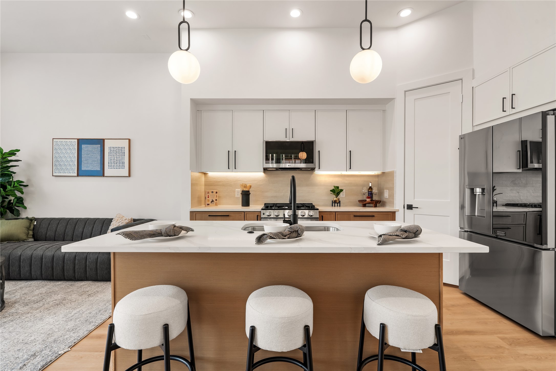 Gourmet kitchen featuring a central social island with seating and an undermount sink.