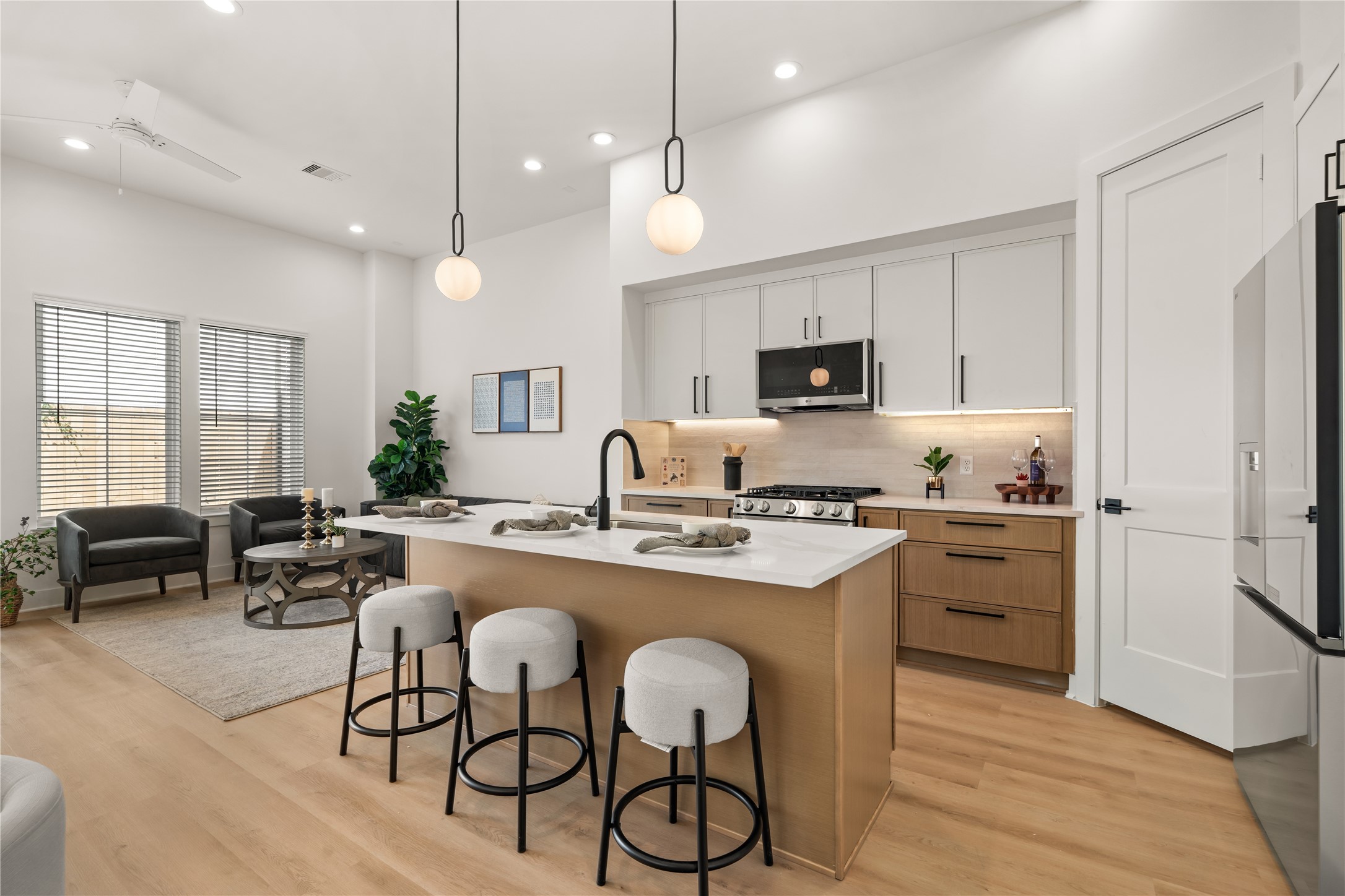 First floor living with 11 foot ceilings! Gourmet kitchen centered around a social island with seating and quartz countertops.