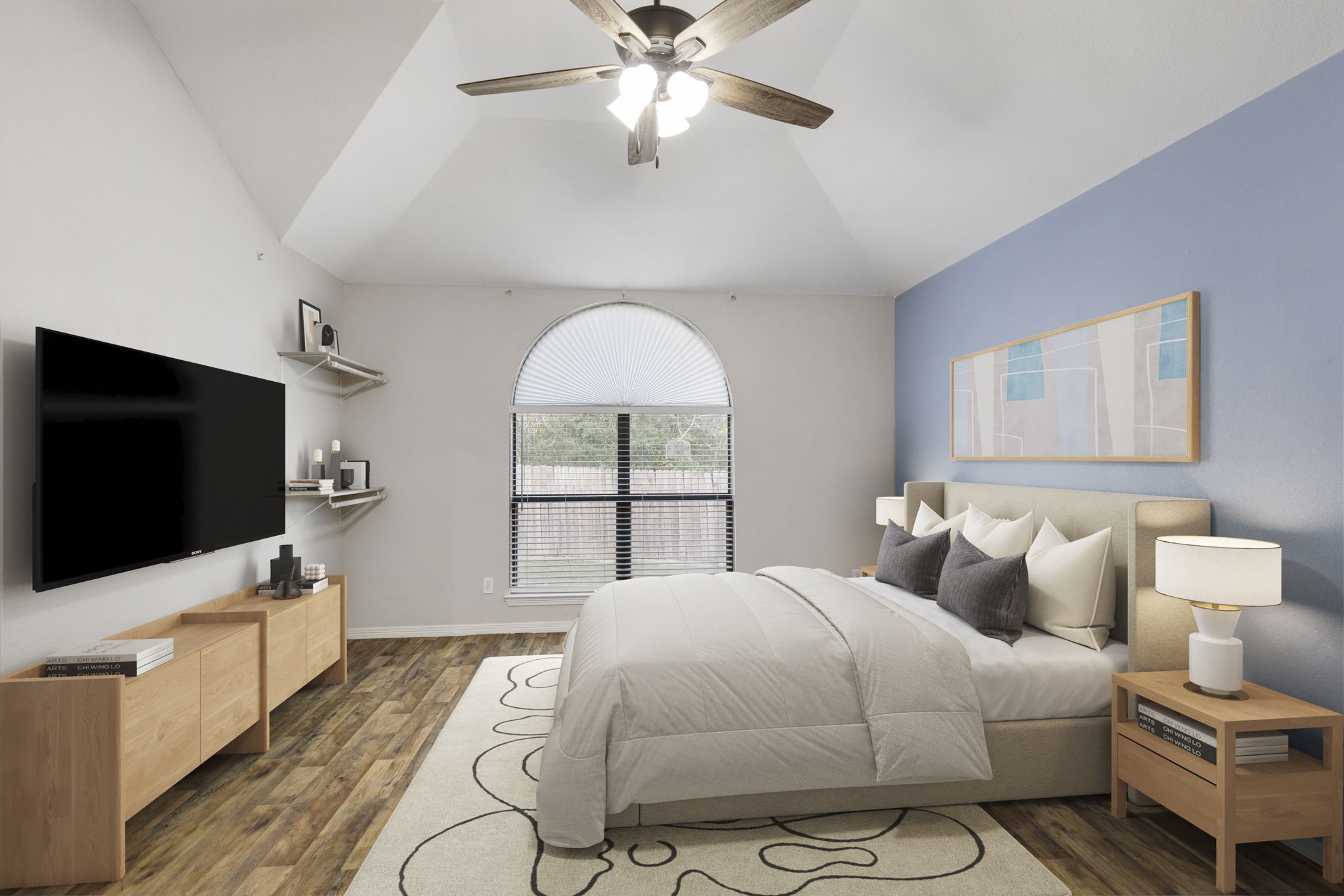Experience serene luxury in this spacious primary bedroom, featuring vaulted ceilings, elegant wood flooring, and a soothing color palette, perfect for relaxation and comfort.