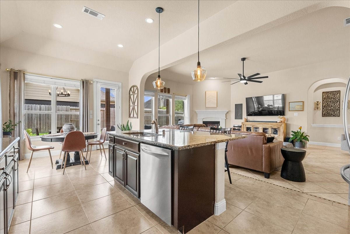 The chef-inspired kitchen with 42" cabinetry, crown molding, granite countertops, designer backsplash, stainless steel appliances, walk-in pantry, and butlers pantry.