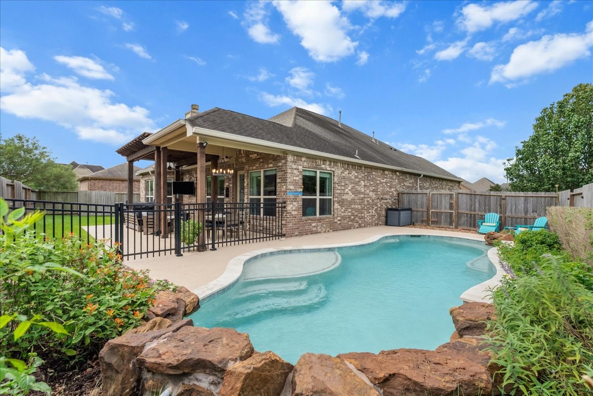 Step outside to your private backyard oasis featuring a sparkling pool, extended patio perfect for entertaining, and plenty of additional yard space for the kids to play.
