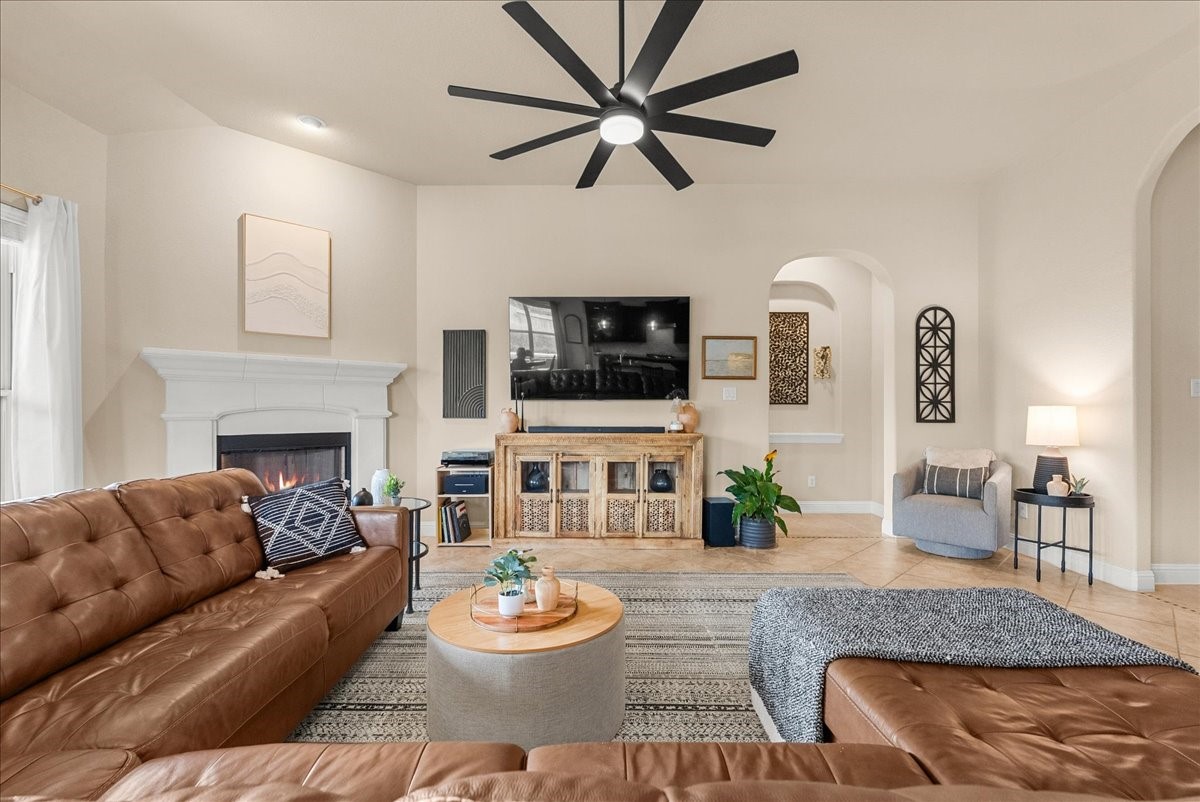 The open-concept living area features a cozy fireplace and flows seamlessly into the chef-inspired kitchen