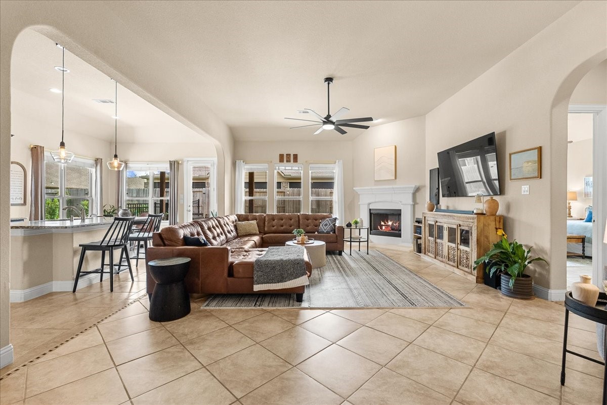 The open-concept living area features a cozy fireplace and flows seamlessly into the chef-inspired kitchen