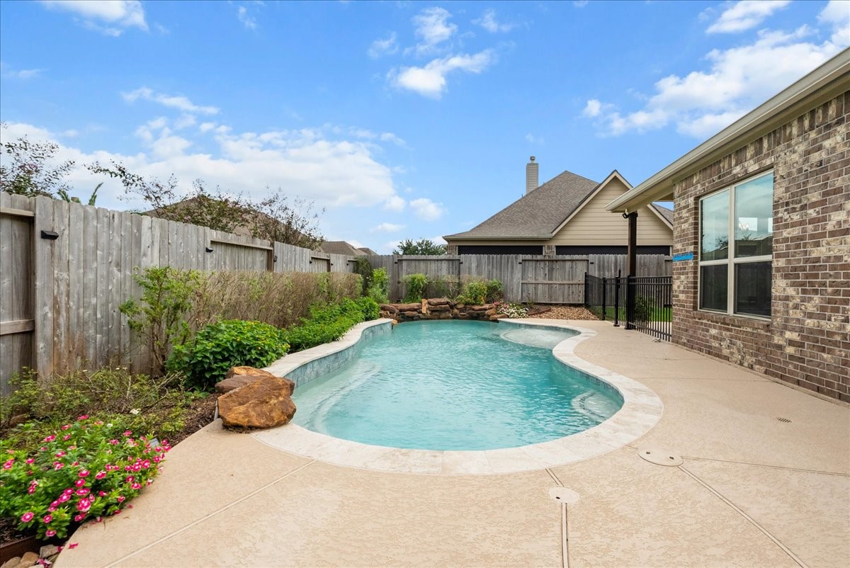 Step outside to your private backyard oasis featuring a sparkling pool, extended patio perfect for entertaining, and plenty of additional yard space for the kids to play.