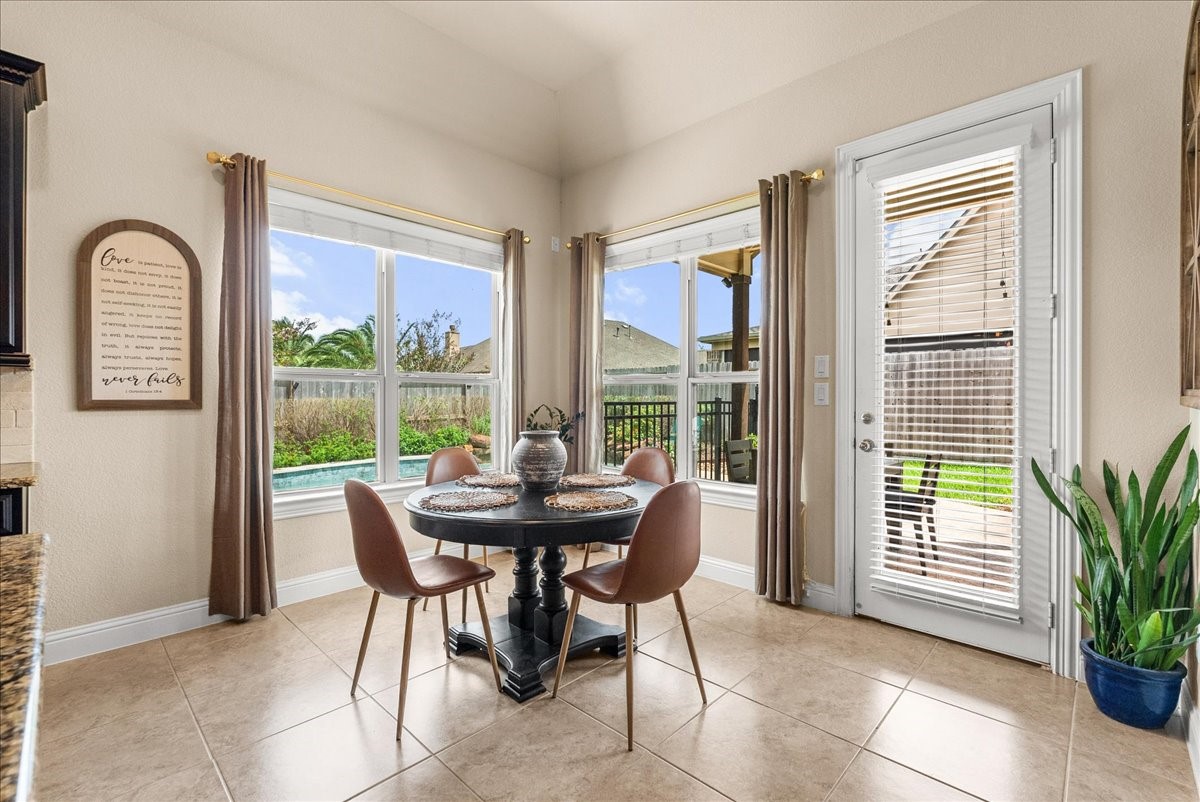Enjoy morning coffee in the breakfast area overlooking the backyard oasis.