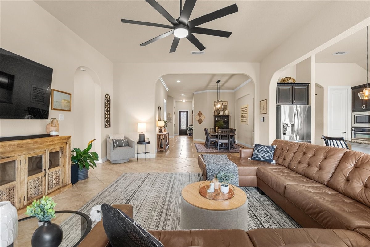The open-concept living area features a cozy fireplace and flows seamlessly into the chef-inspired kitchen