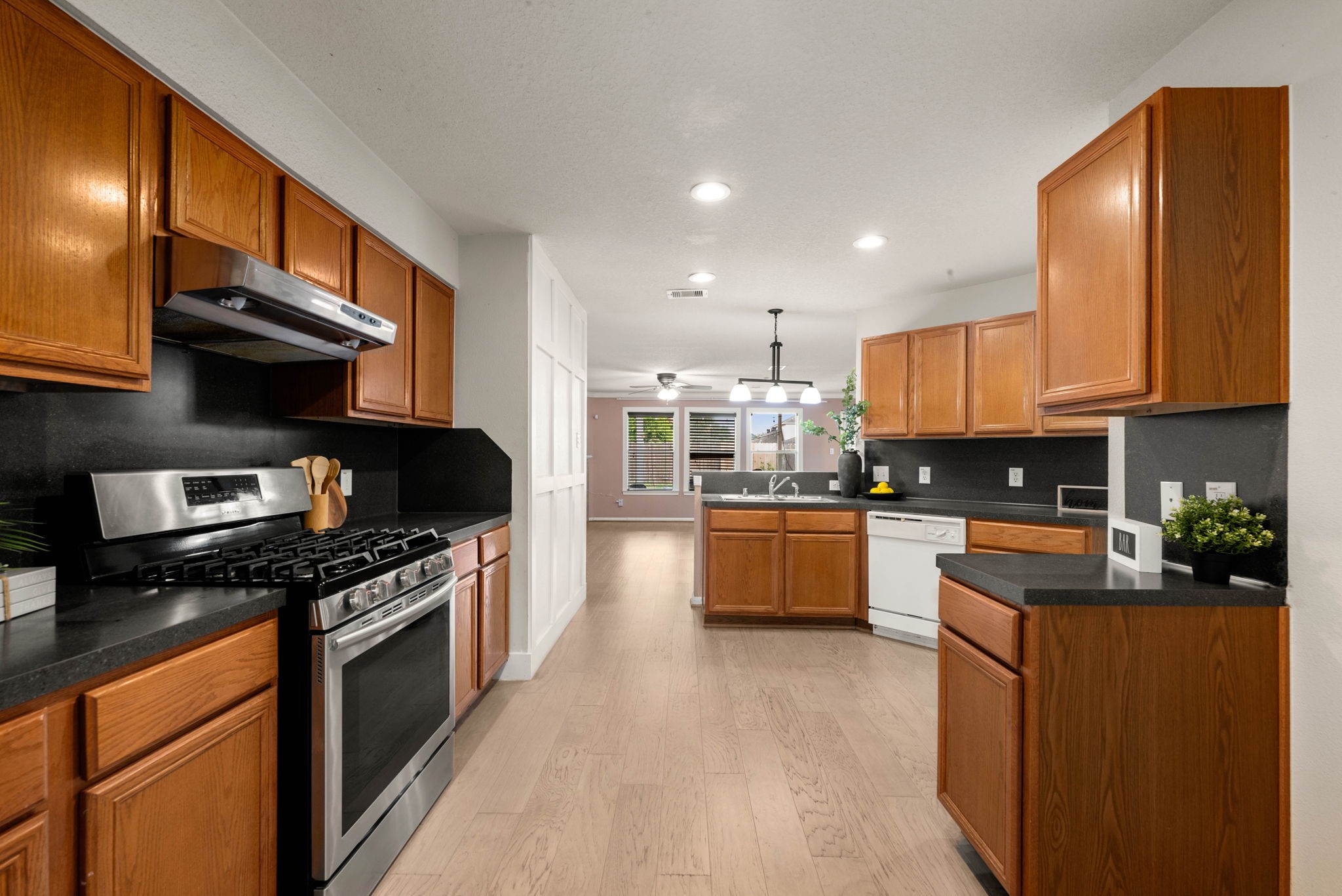 Kitchen features ample cabinetry, stainless steel appliances, and generous counter space for meal prep.