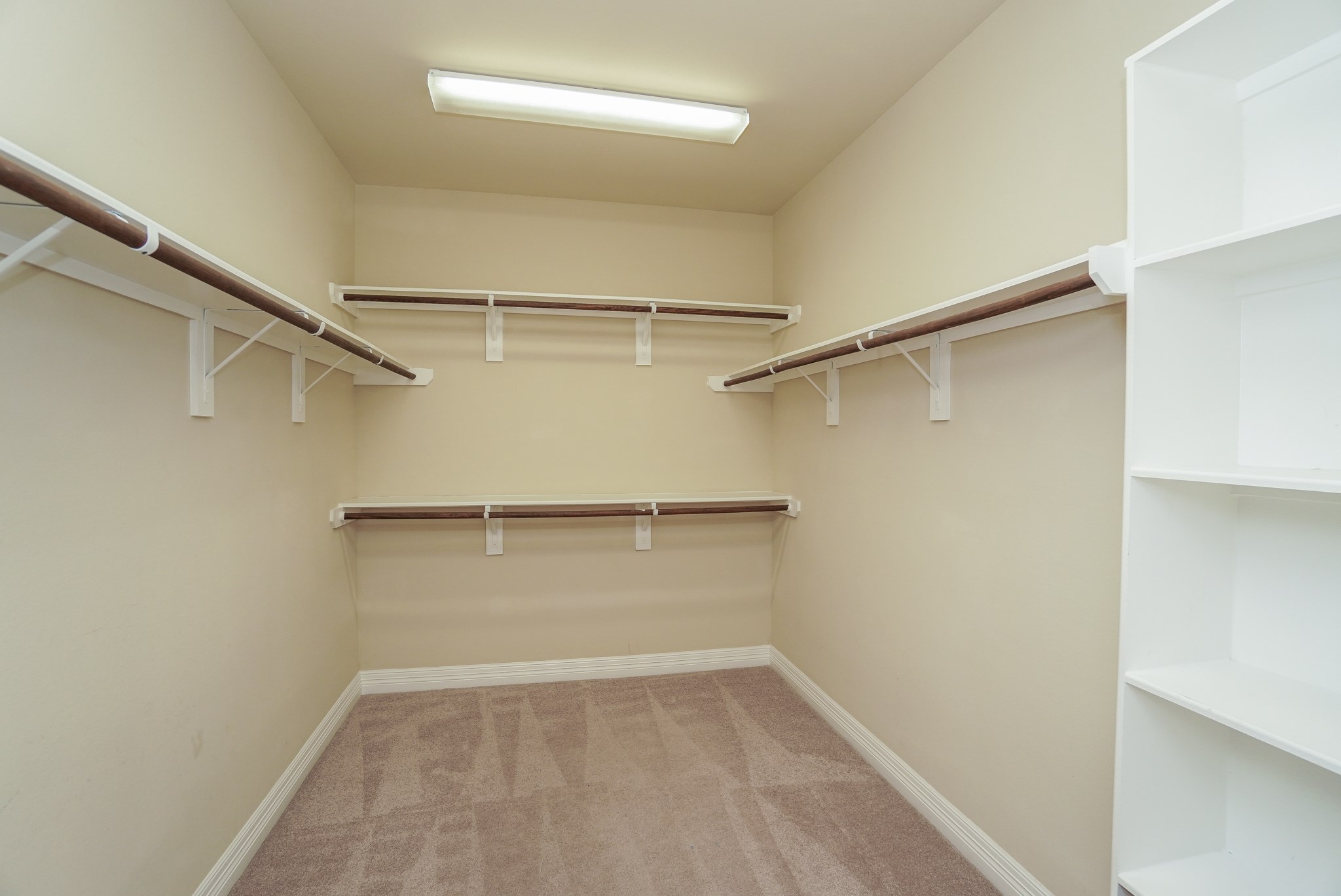 The Primary Bedroom closet has a built in shelf and EXTRA storage under the staircase.