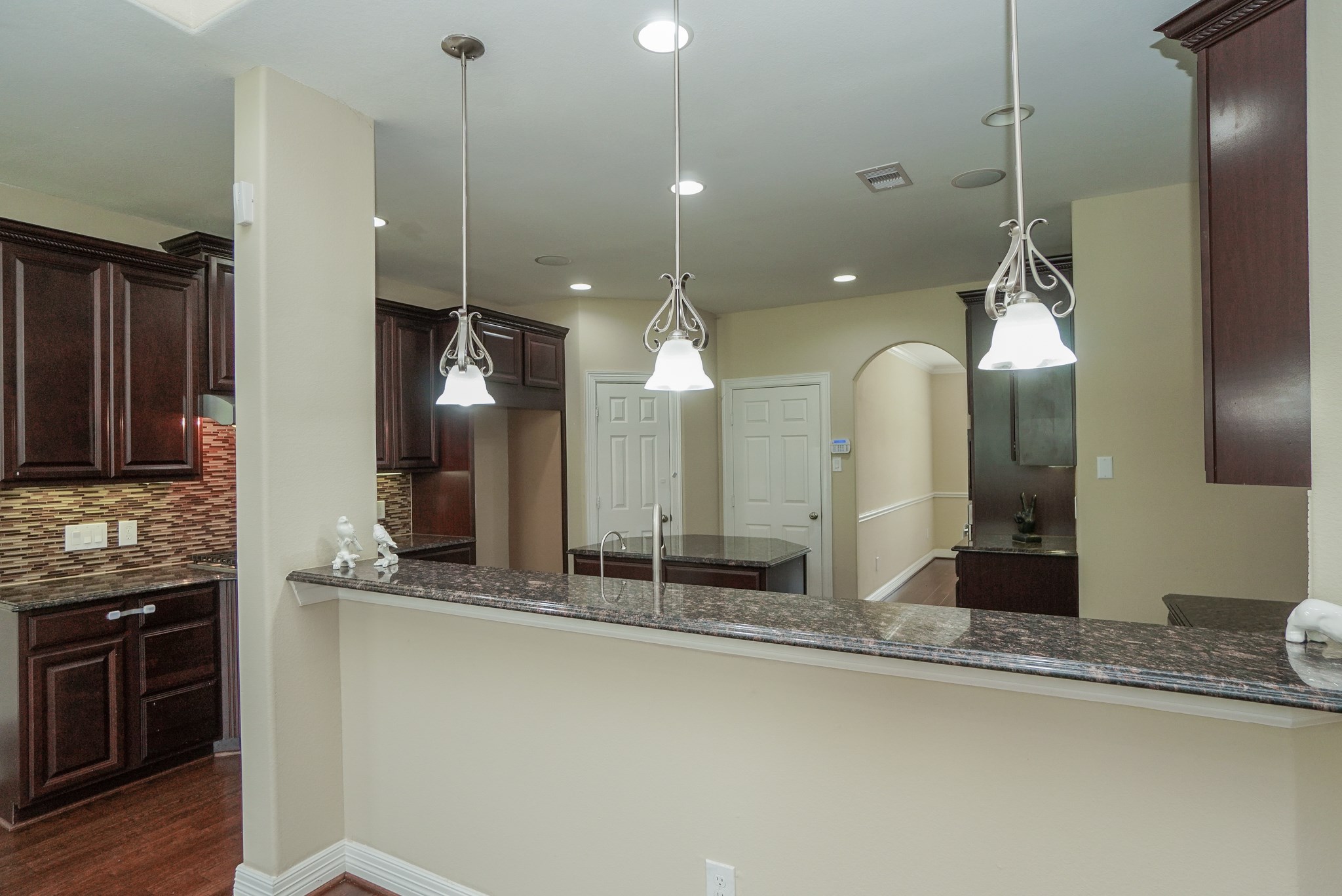 The kitchen is the heart of the home: complete with upgraded lighting and granite countertops.