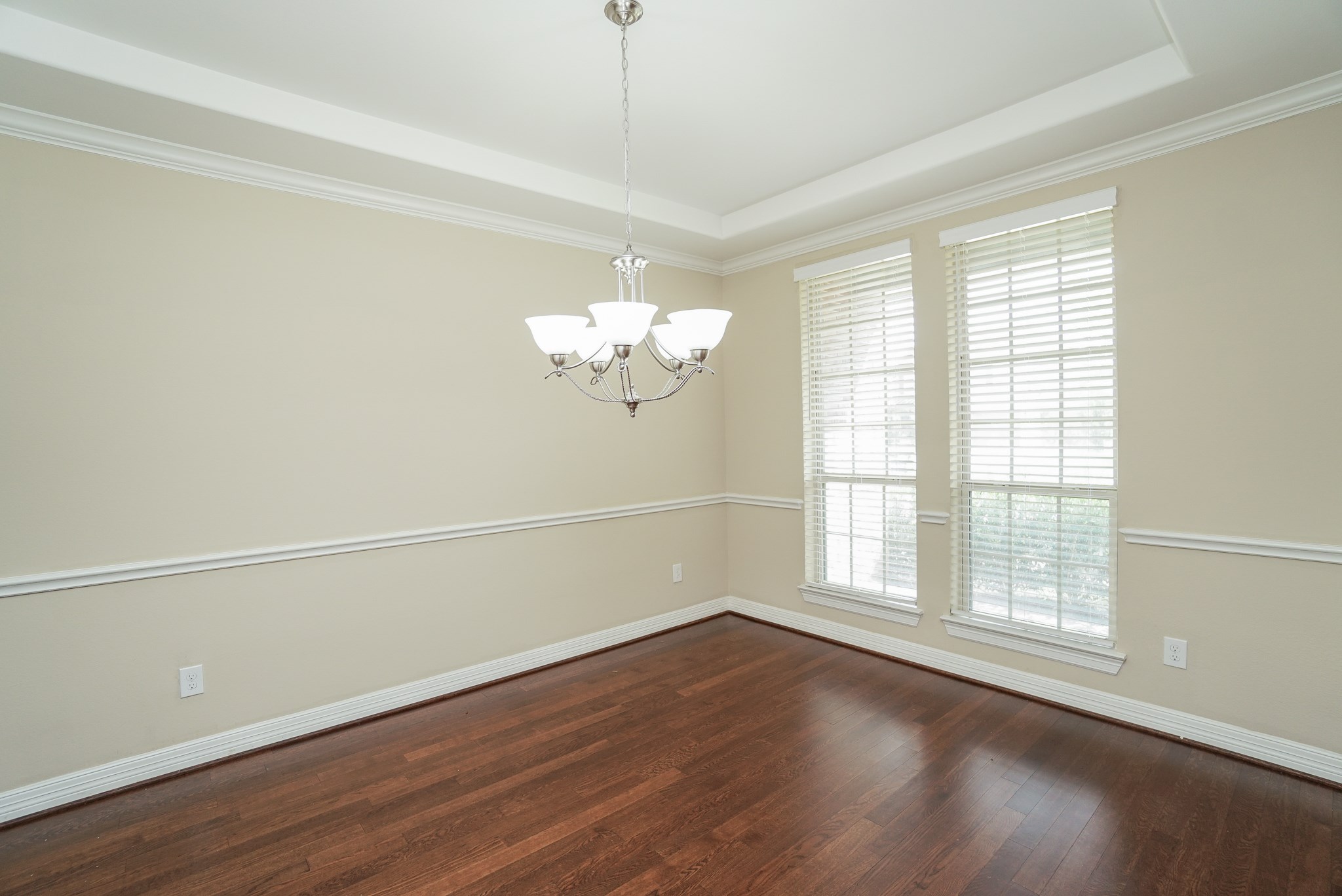 The formal dining room is on the right side of the front door. Neutral paint, extensive crown molding and rich hardwood flooring add to the elegance of this space. The formal dining room is on the right side of the front door. Neutral paint, extensive crown molding and rich hardwood flooring add to the elegance of this space.
