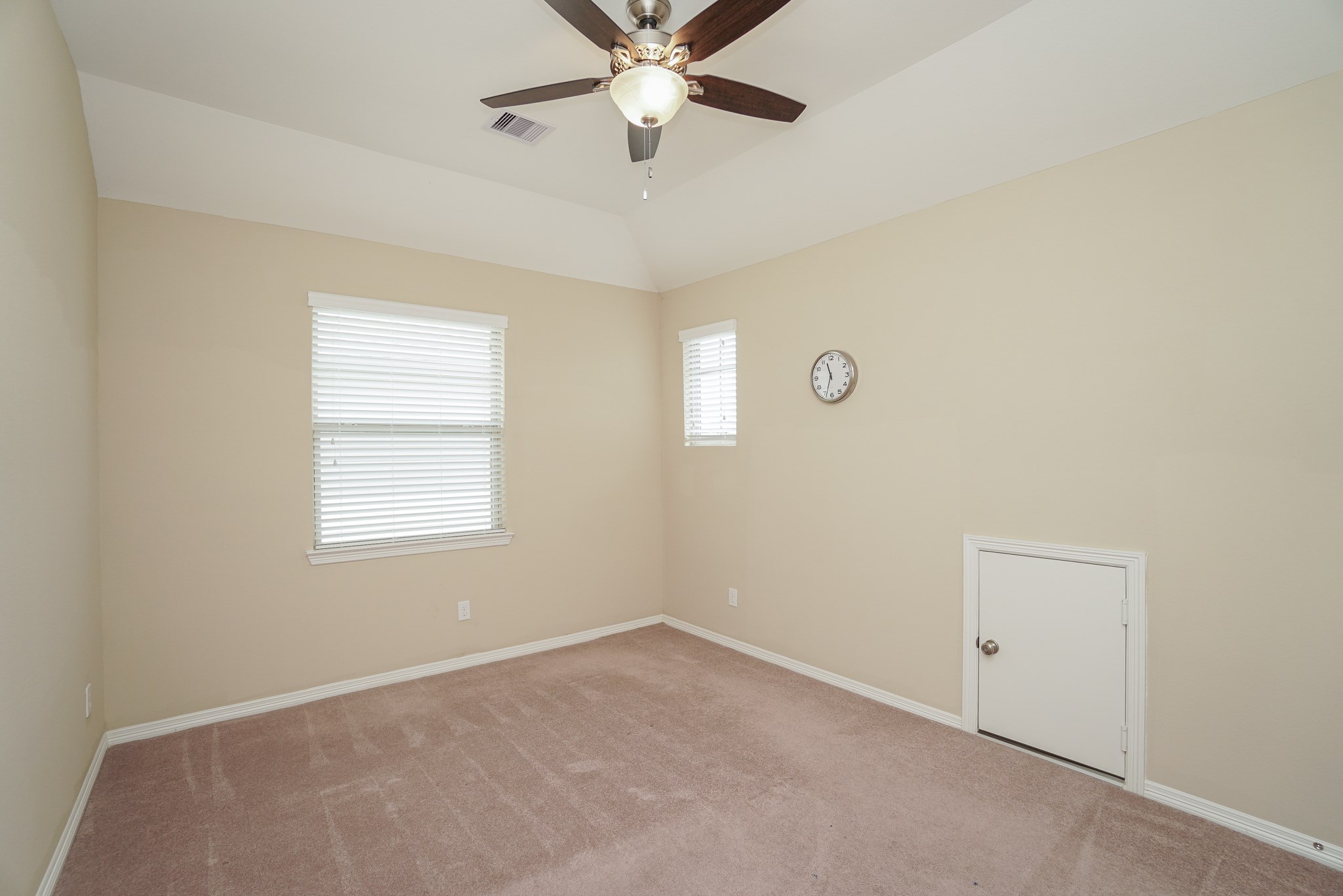 This guest bedroom features a fan and has a Jack & Jill bathroom connecting the rooms.