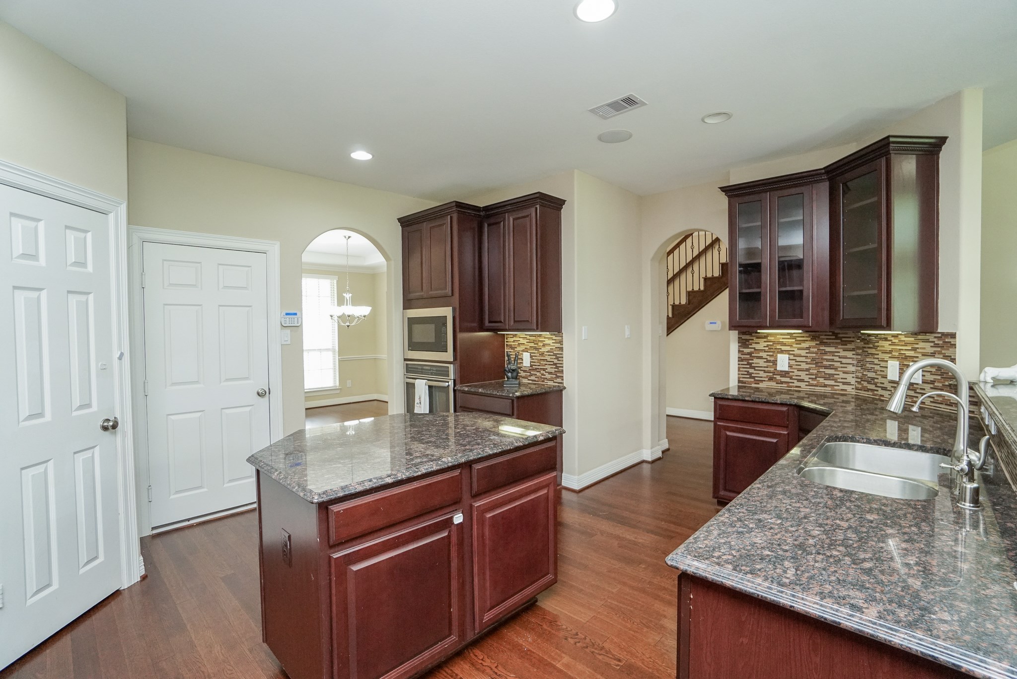 The kitchen features warm colors with granite and glass tile backsplash, gas cook top, large pantry and plenty of room for your culinary treasures.