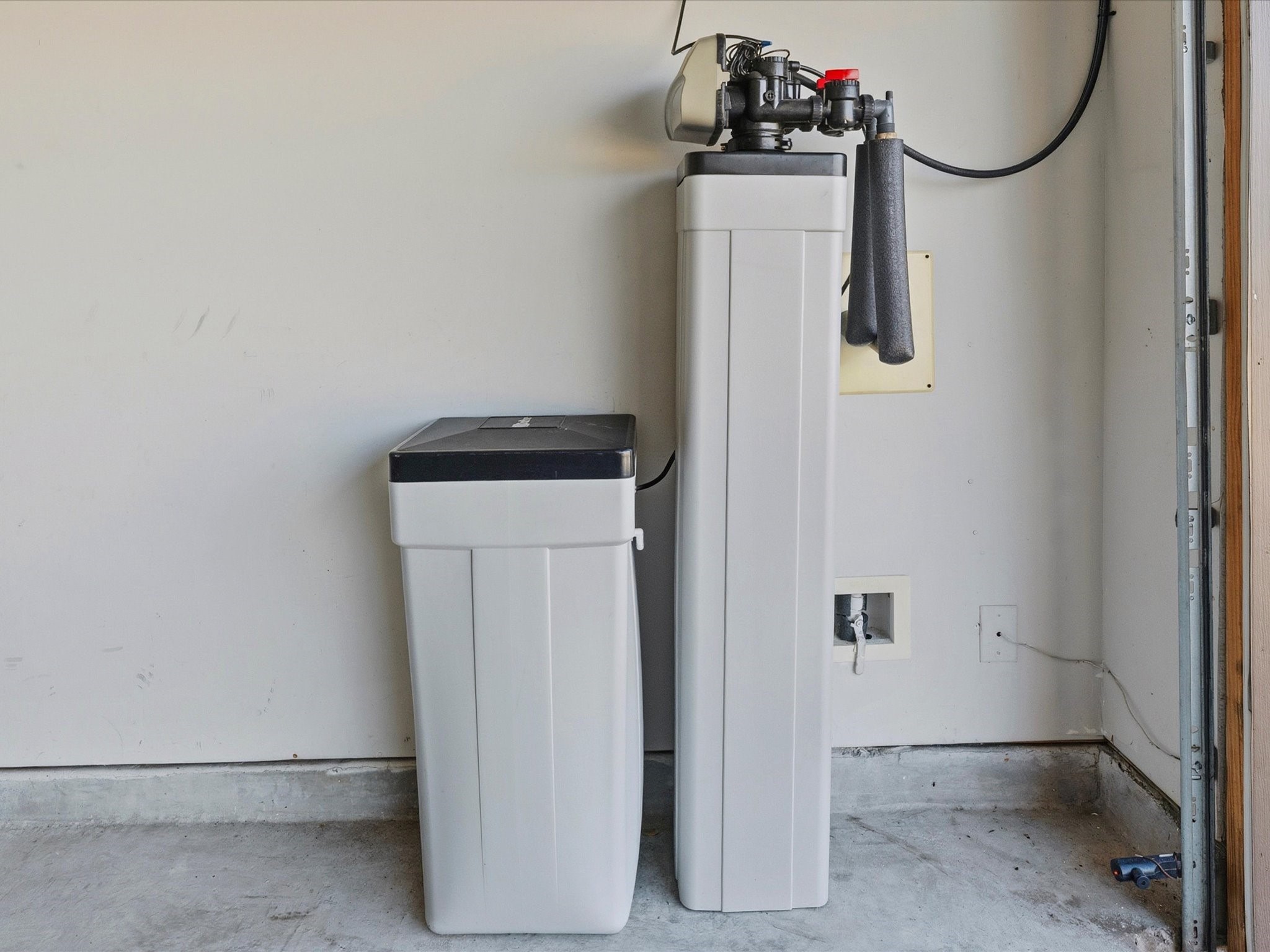 Located safely in the garage, a whole house water softener system.
