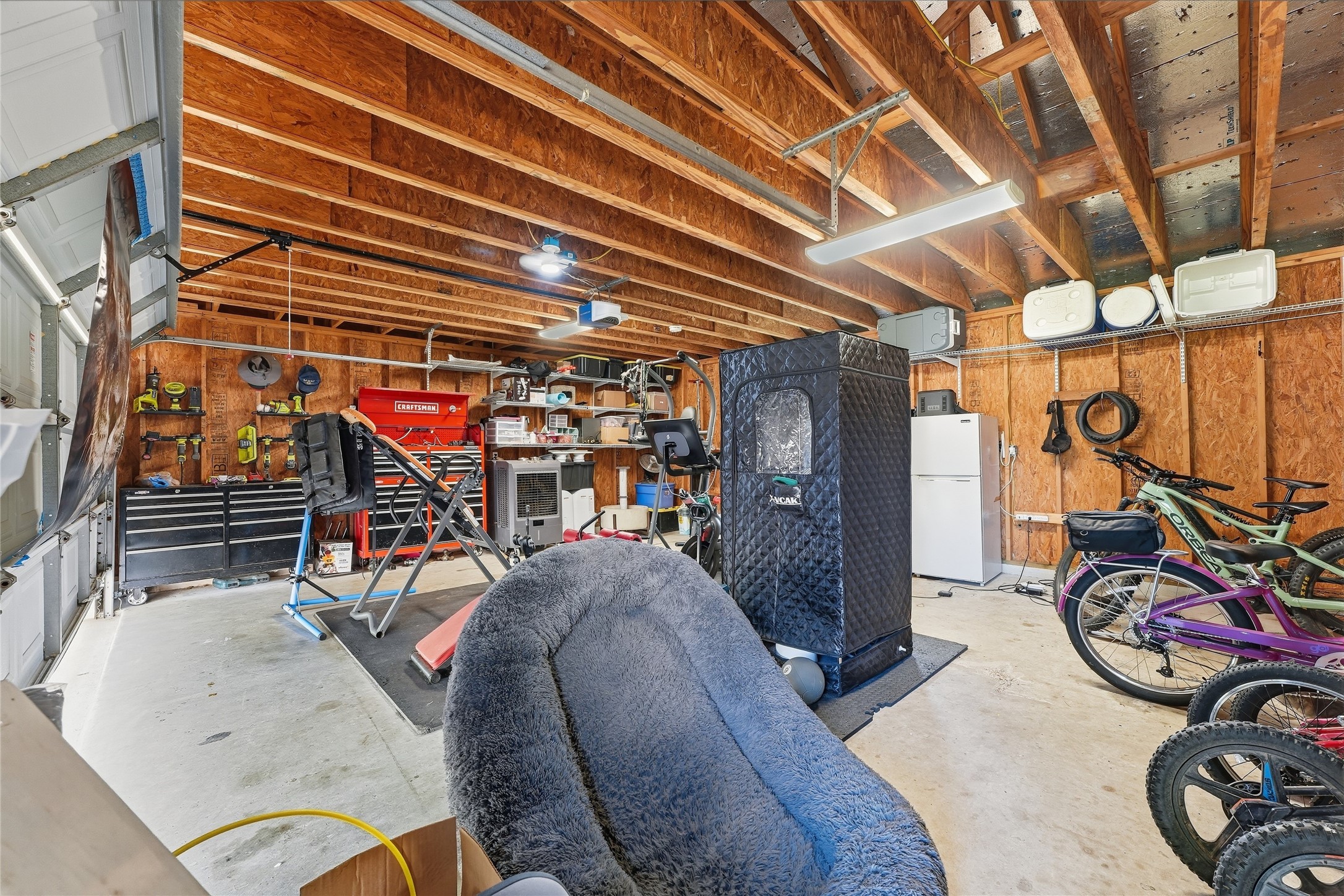 This air-conditioned two-car garage offers comfortable space for your vehicles, a home gym or hobbies, with covered parking directly in front for added flexibility. This air-conditioned two-car garage offers comfortable space for your vehicles, a home gym or hobbies, with covered parking directly in front for added flexibility.