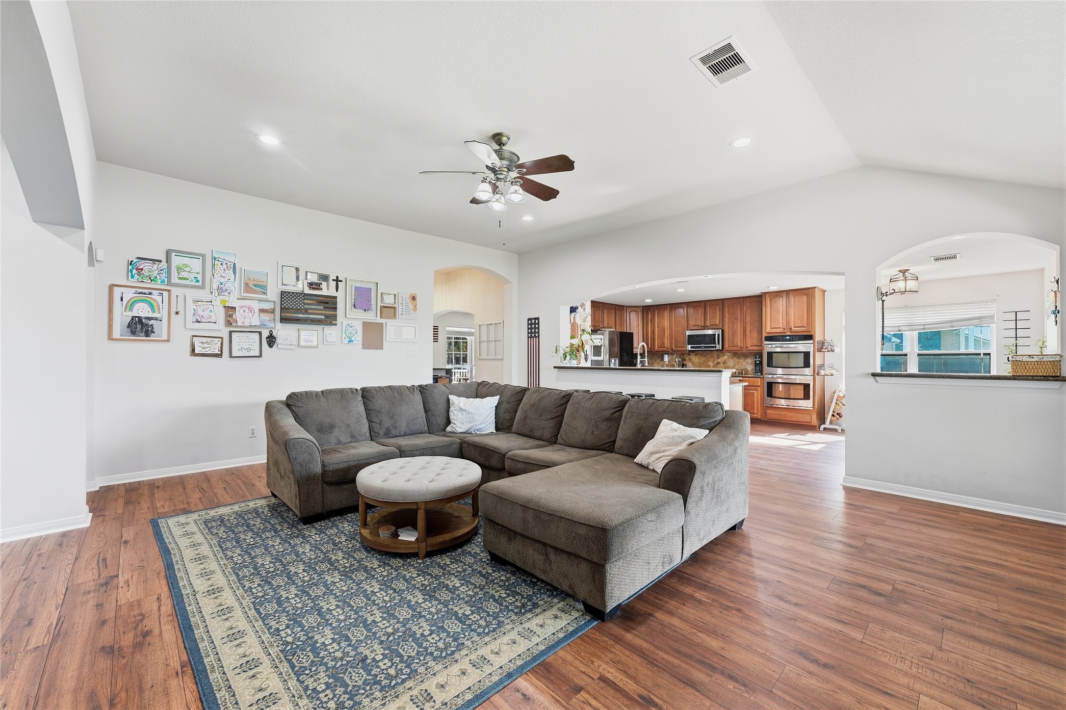 Vaulted ceilings give the family room a spacious, airy feel, while abundant natural light and an open layout create a bright, welcoming space for everyday living and entertaining.