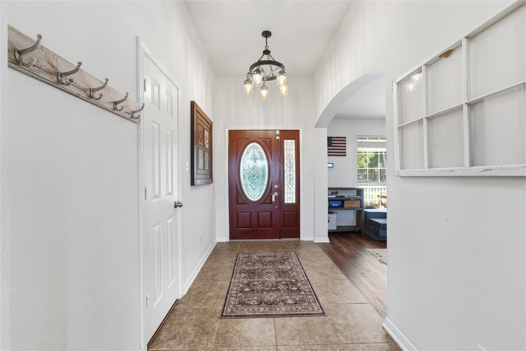 Entry with ceramic tile flooring and a convenient hall closet to keep coats and everyday essentials tucked away.