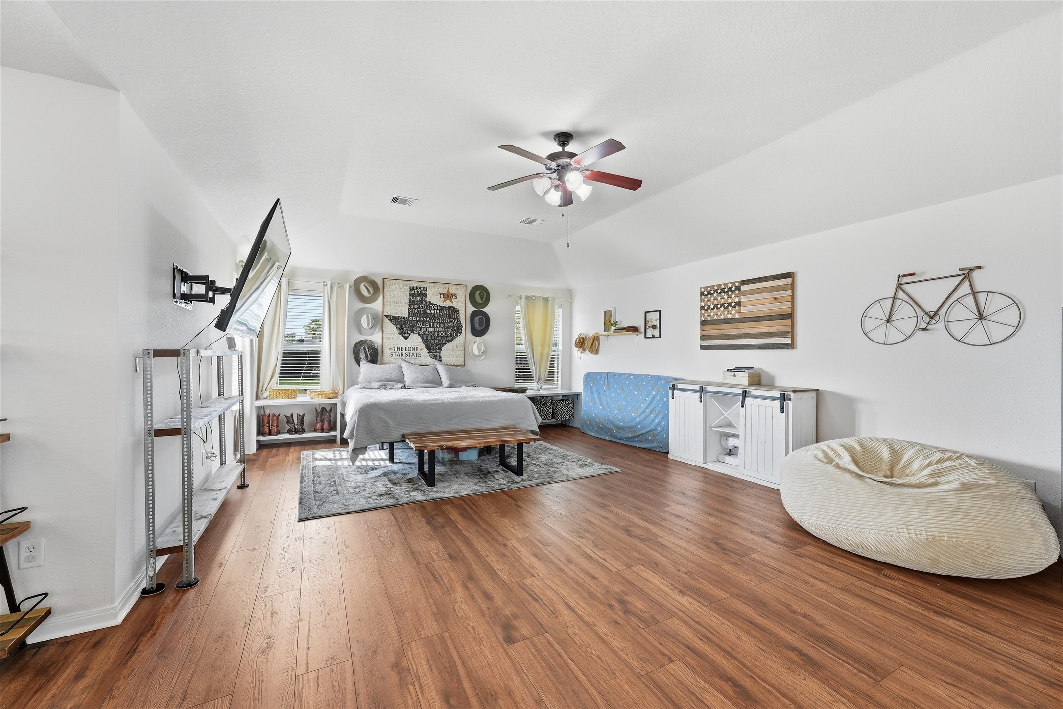 The spacious 22x21 primary bedroom features vaulted ceilings and room for a home office, cozy reading nook or workout area.
