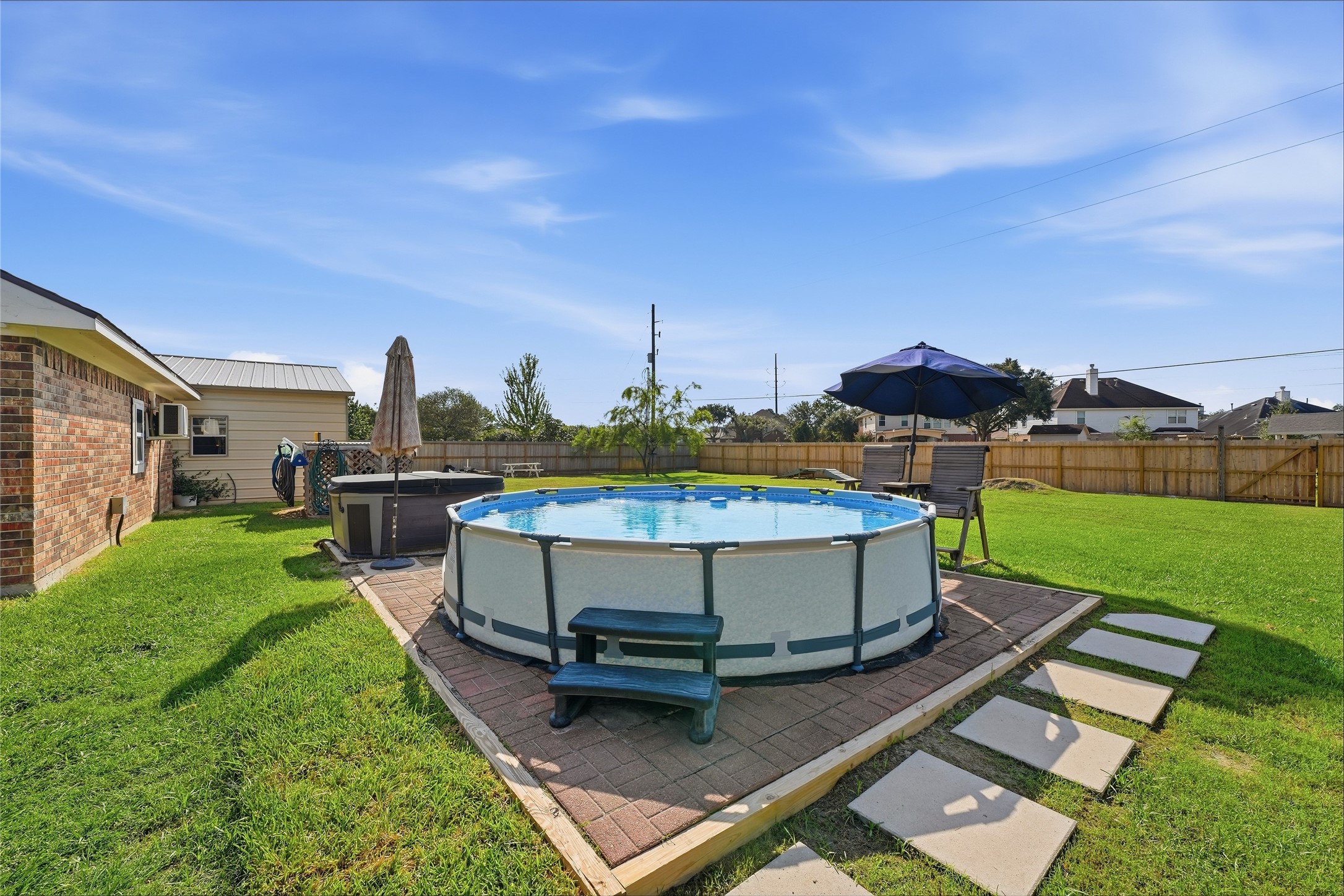 The above-ground pool is included in the saleready for relaxing and cooling off on warm days.