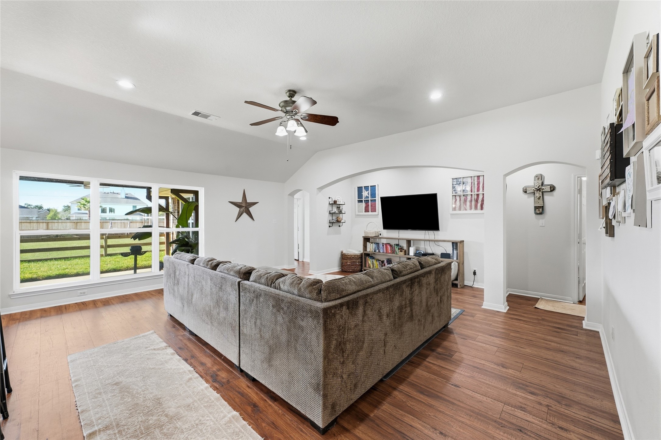 This spacious family room features brand-new LVP flooringa durable, easy-care surface for everyday living and entertaining.