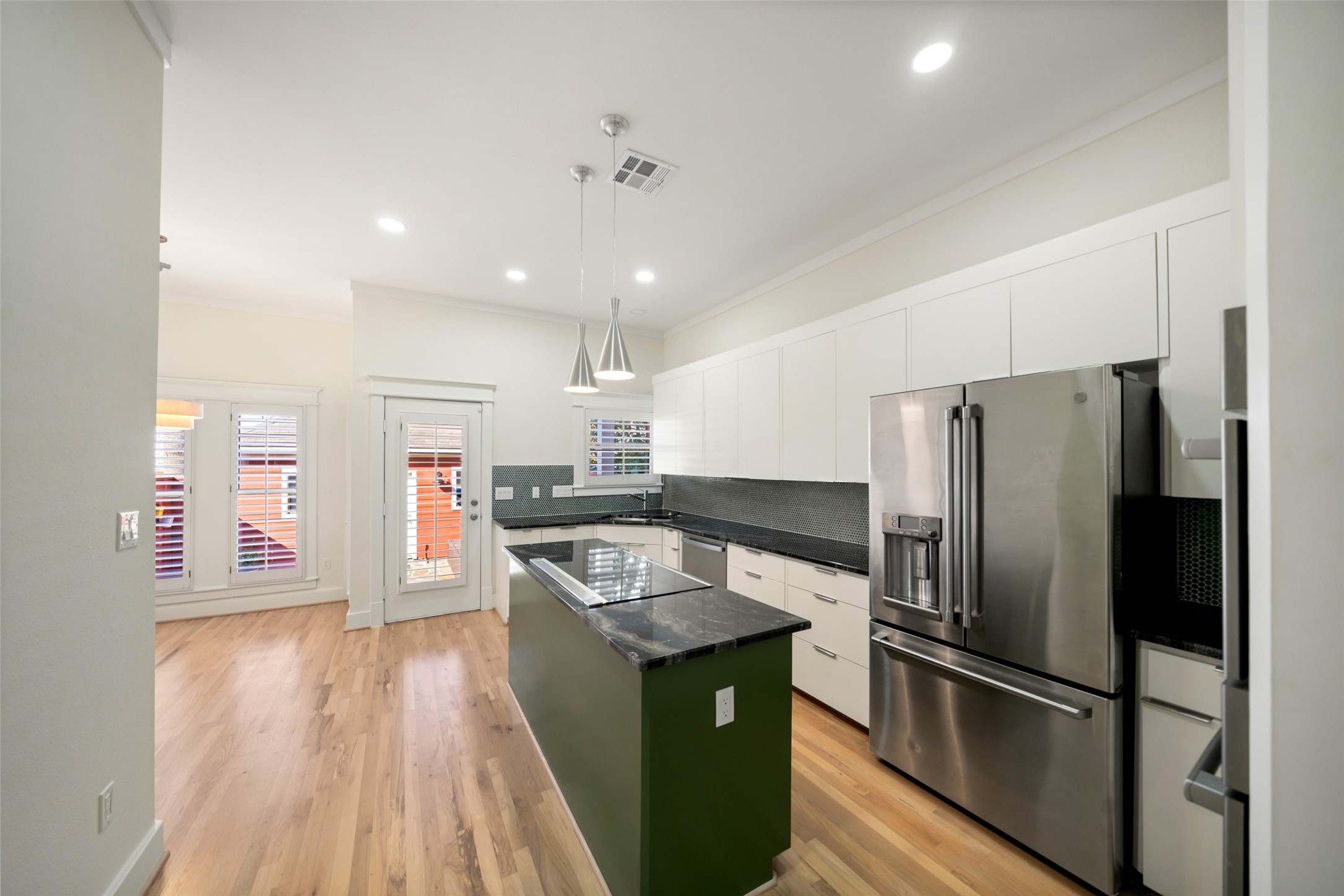 tainless steel appliances, generous cabinetry, and thoughtful details enhance this inviting kitchen.