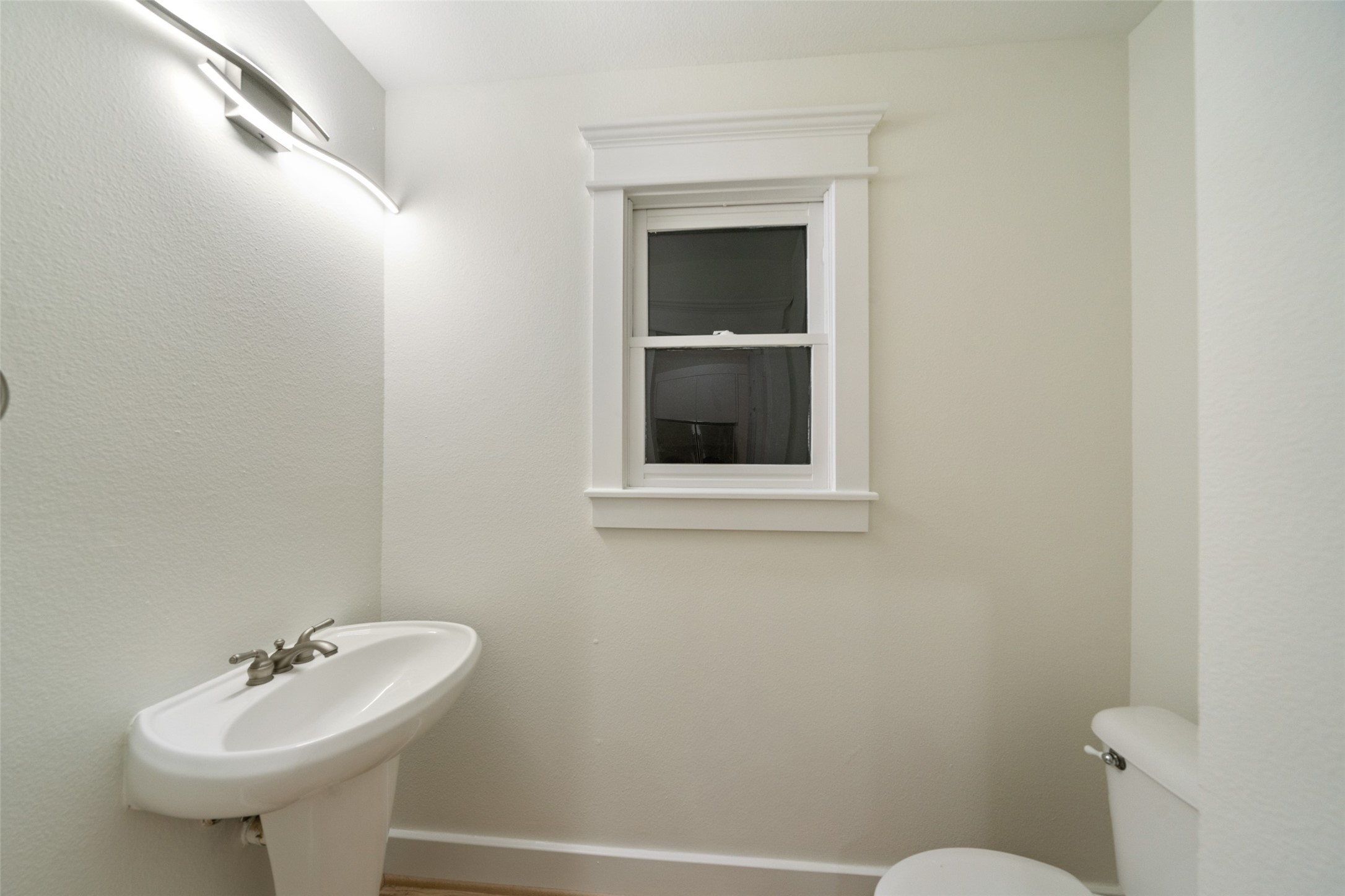 A convenient main-level powder room adds comfort for guests and everyday living.