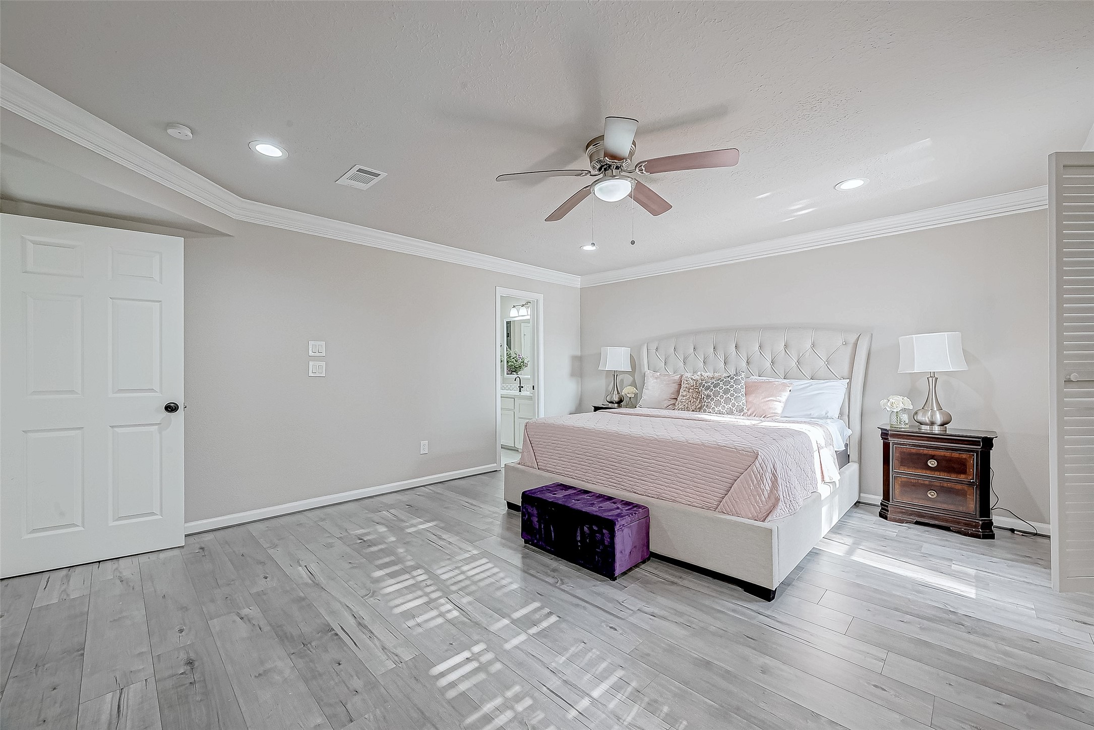 Primary bedroom with elegant finishes and abundant natural light.