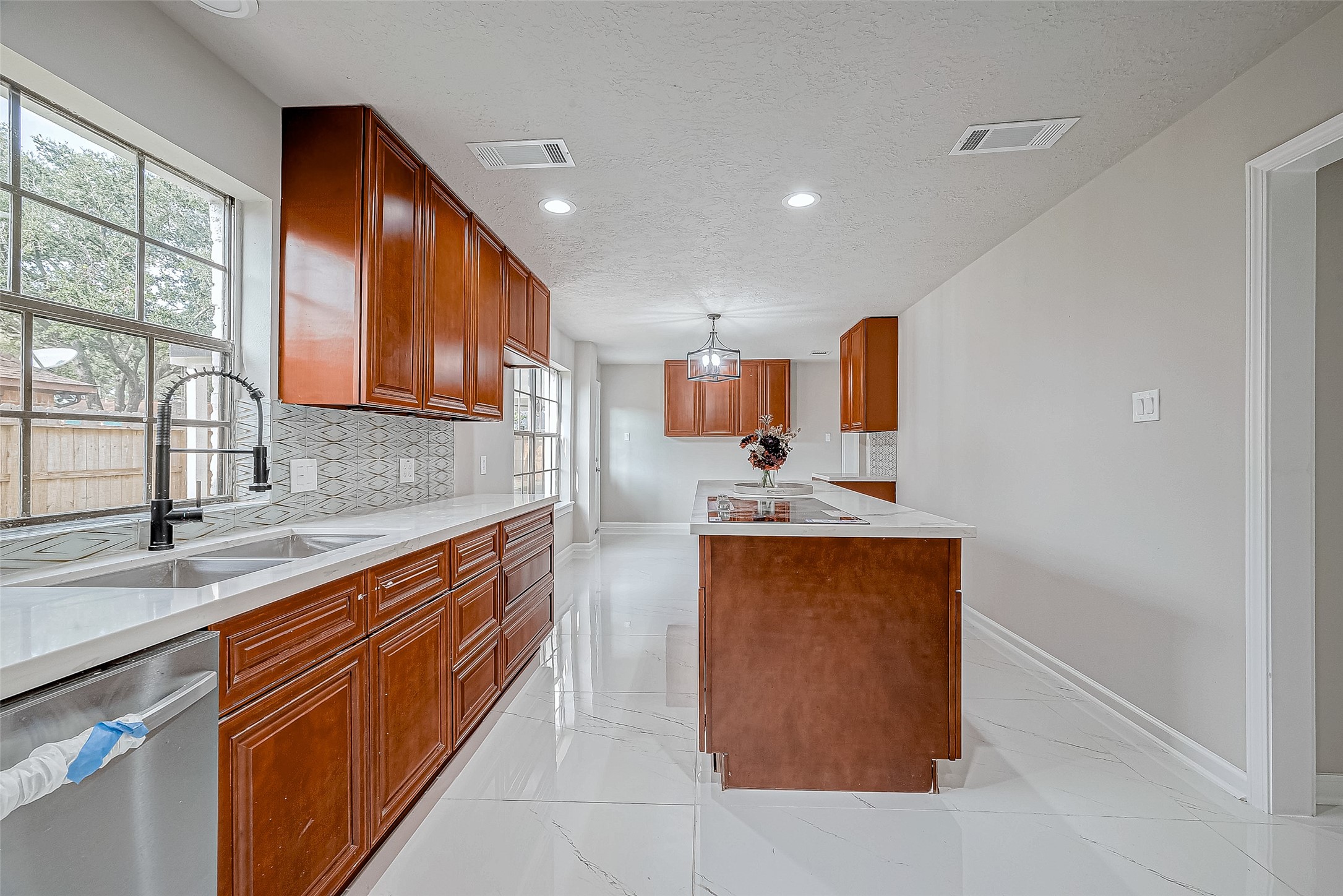 Sleek white countertops and the flooring is stylish and easy to maintain.