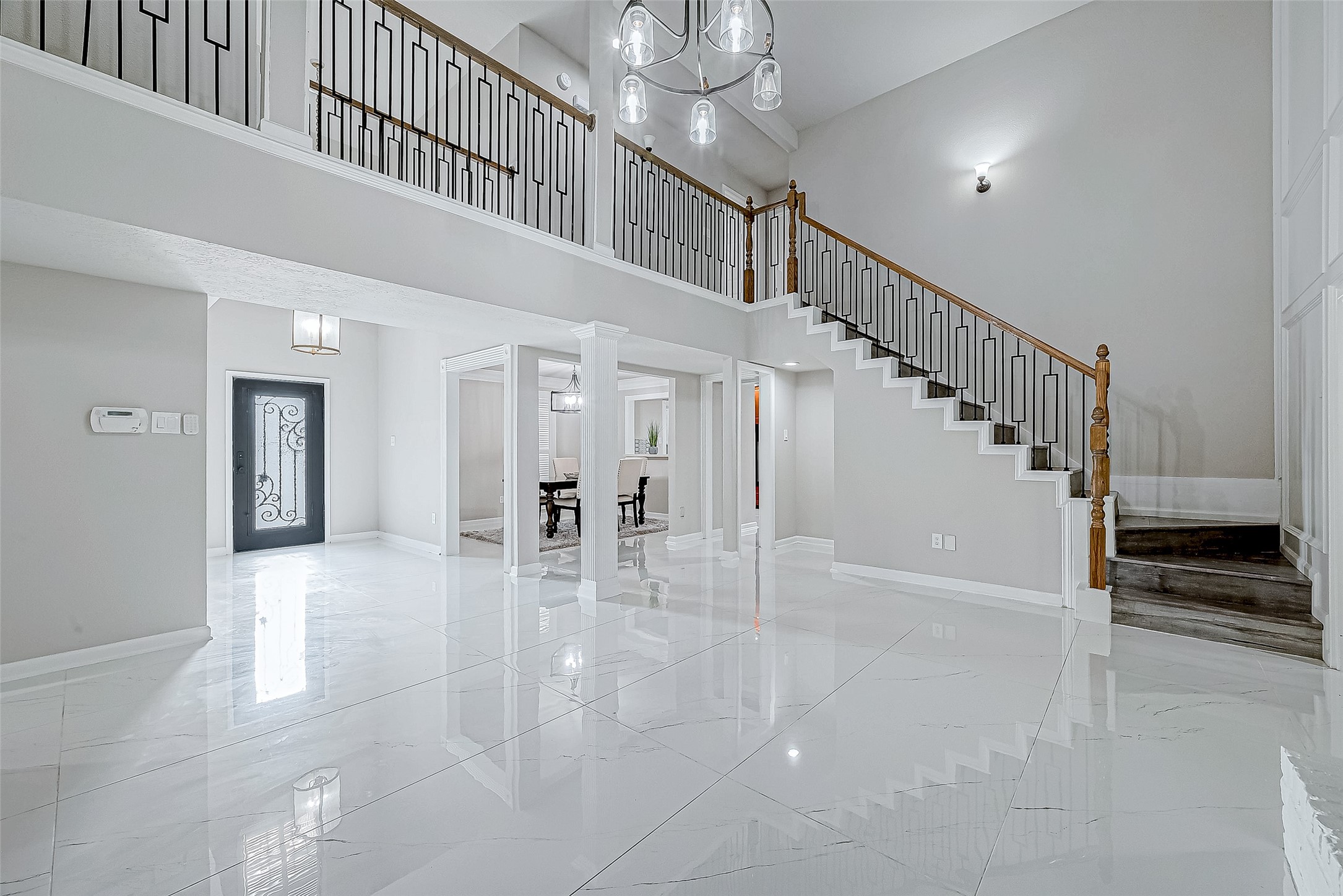 Open foyer with tile flooring and a grand staircase.