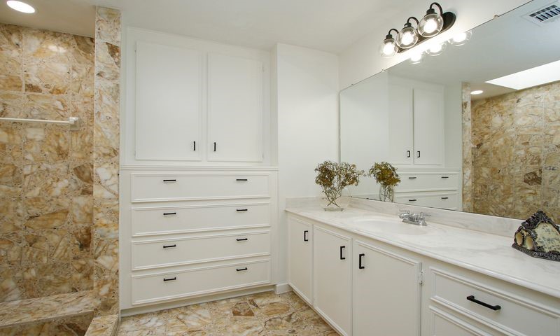 magnificent master bath w/his & hers vanities built in chest of drawers and tones of storage for both sides