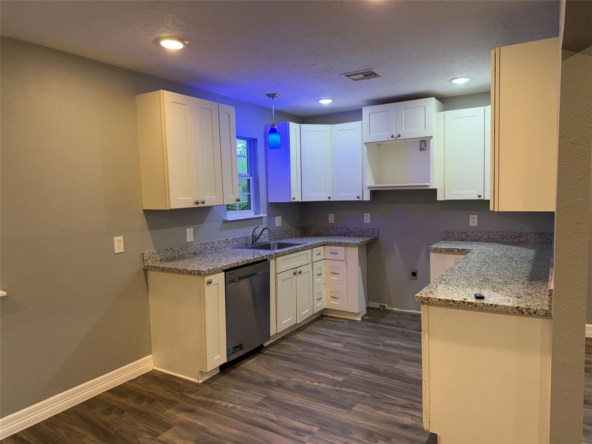 Kitchen w/ granite counters and shaker cabinets