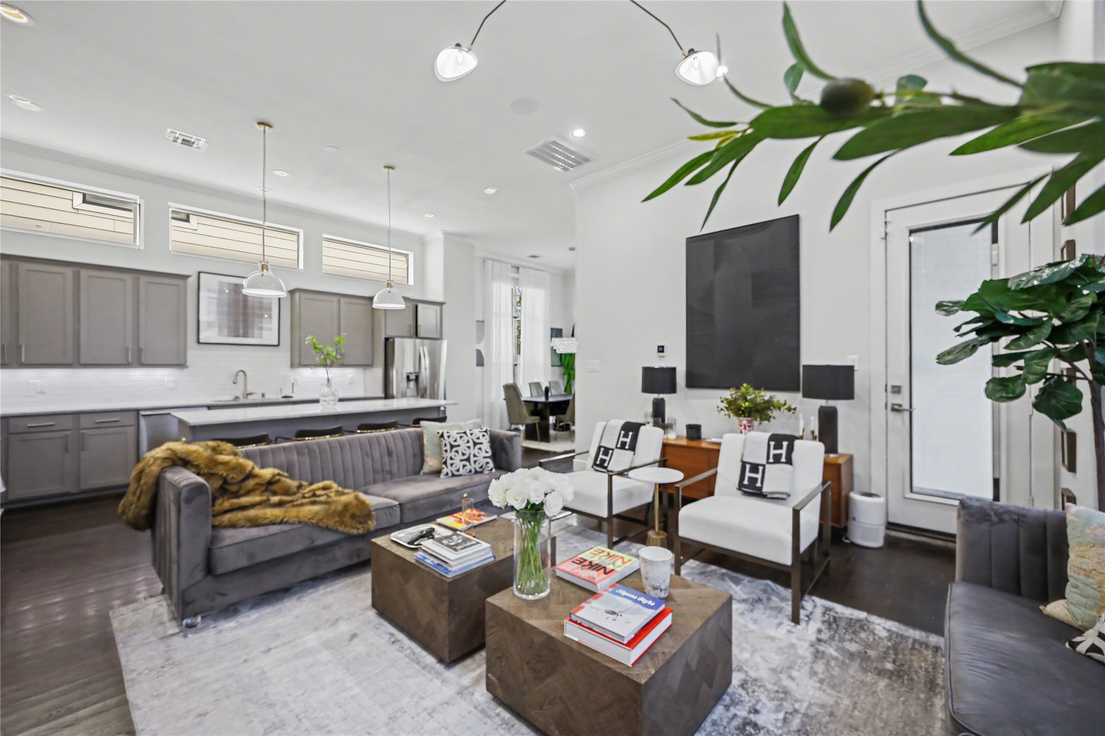 High ceilings and designer finishes and furnishings throughout. Closed door leads to a covered patio, perfect for grilling.