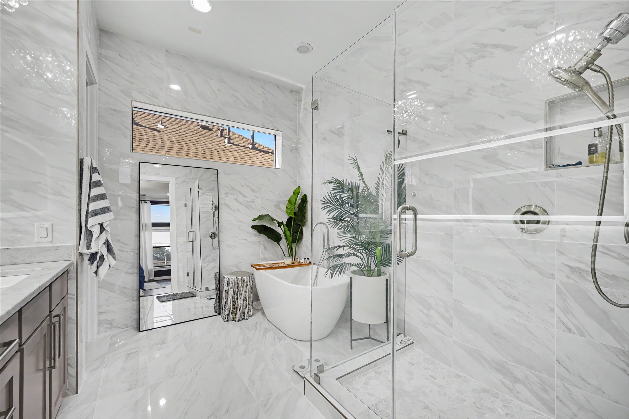 Large walk-in shower with a separate soaking tub in this oversized bathroom.