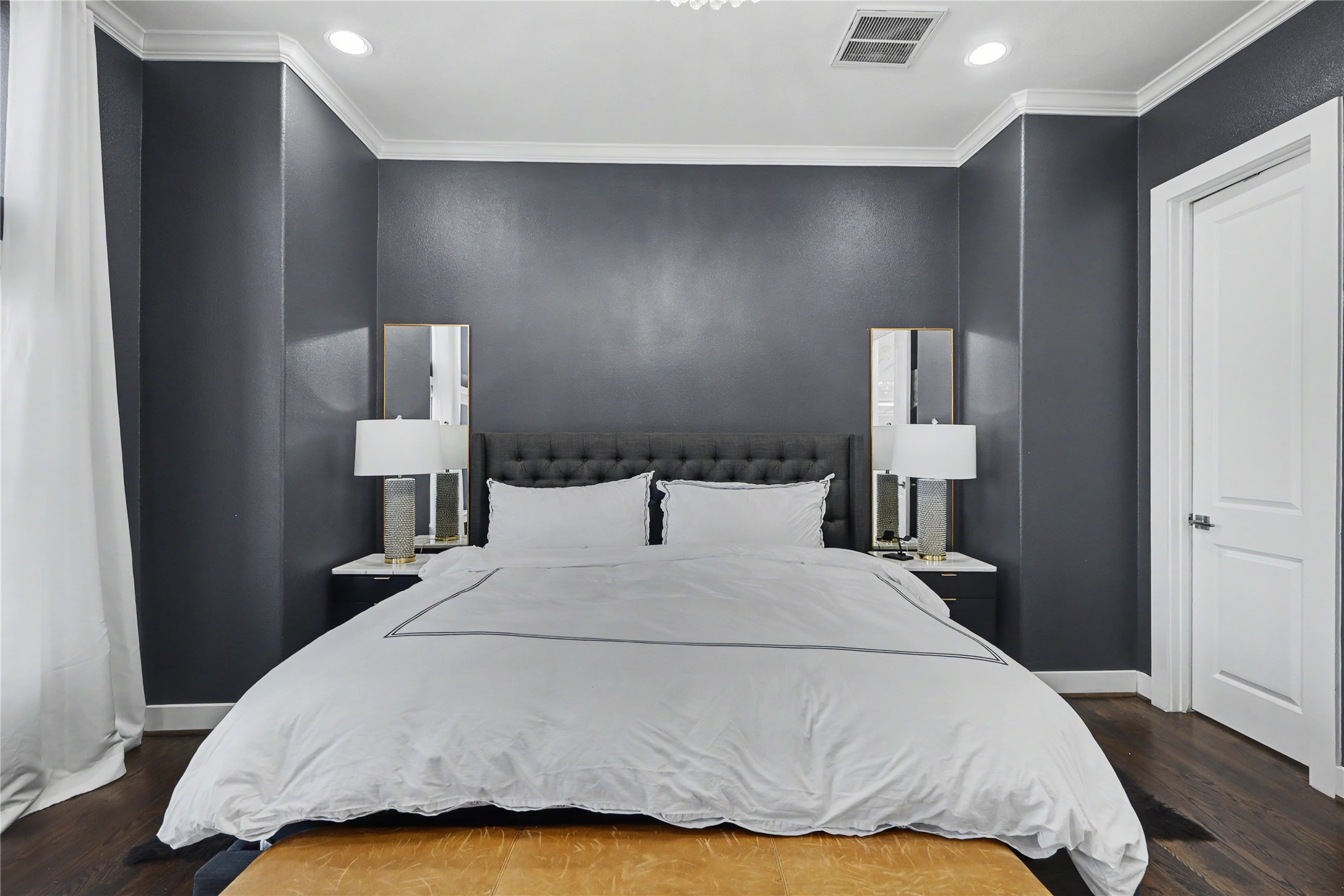 Rest and relaxation will be easy in this primary bedroom suite. Door to the right leads to the spa bath.