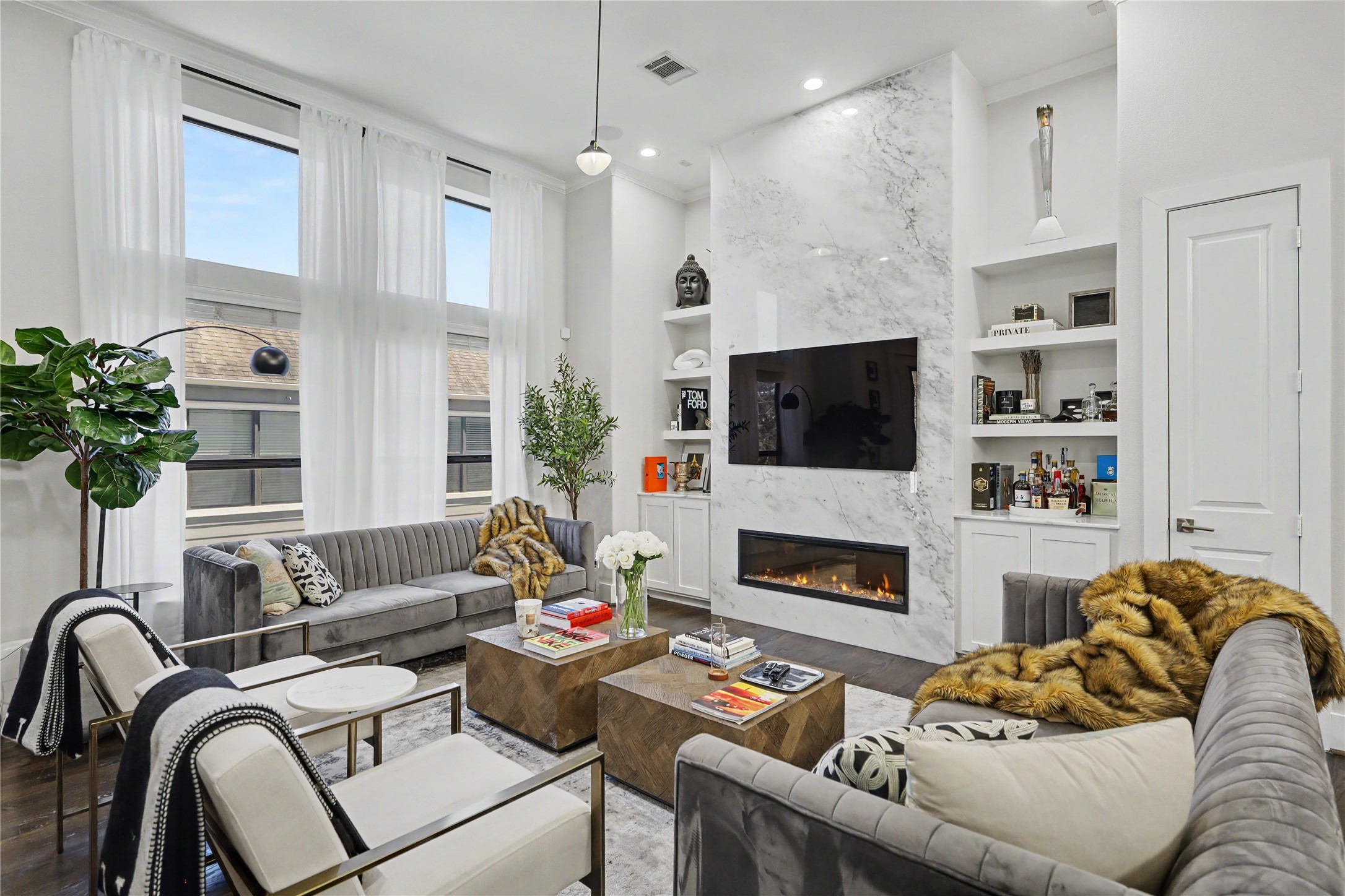 Incredible open-concept living space with high ceilings. All furniture and decor included in this furnished lease.
