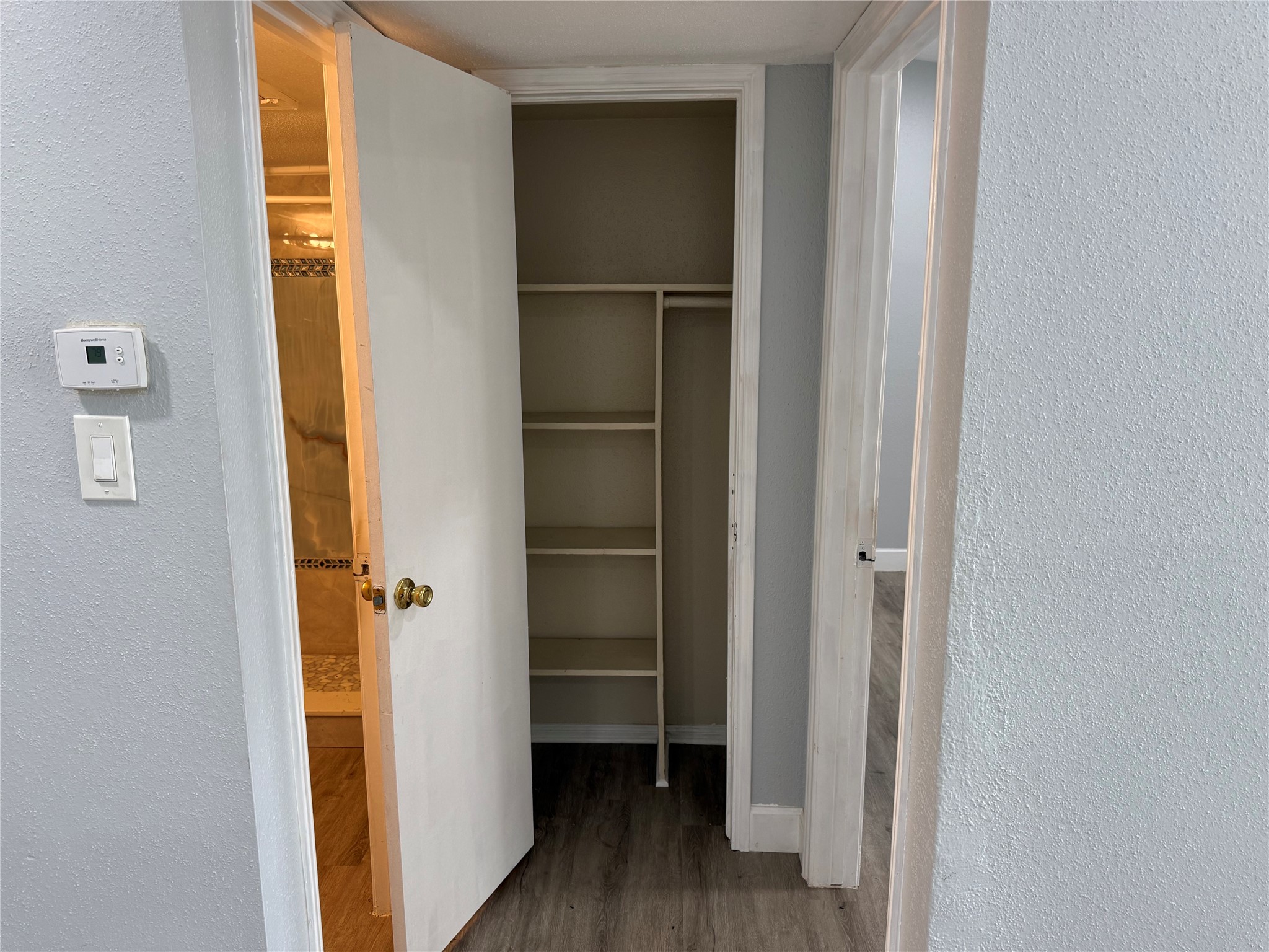 Linen closet located between the bedroom and bathroom.
