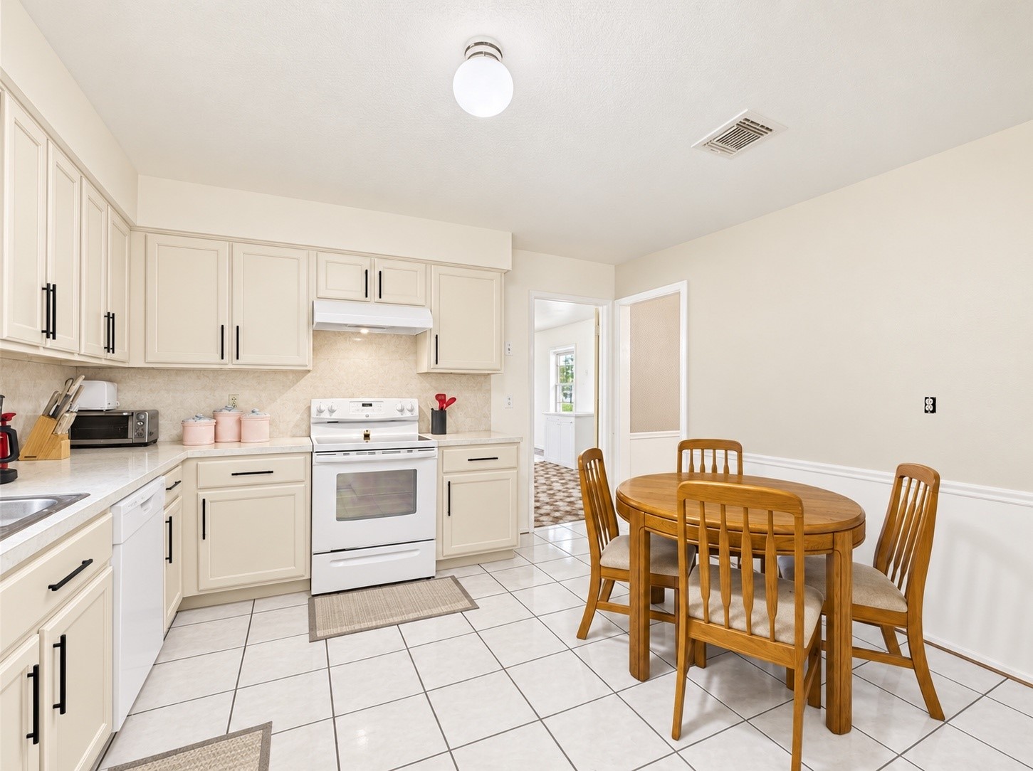Newly painted kitchen cabinets with new hardware really brightens it up in here!
