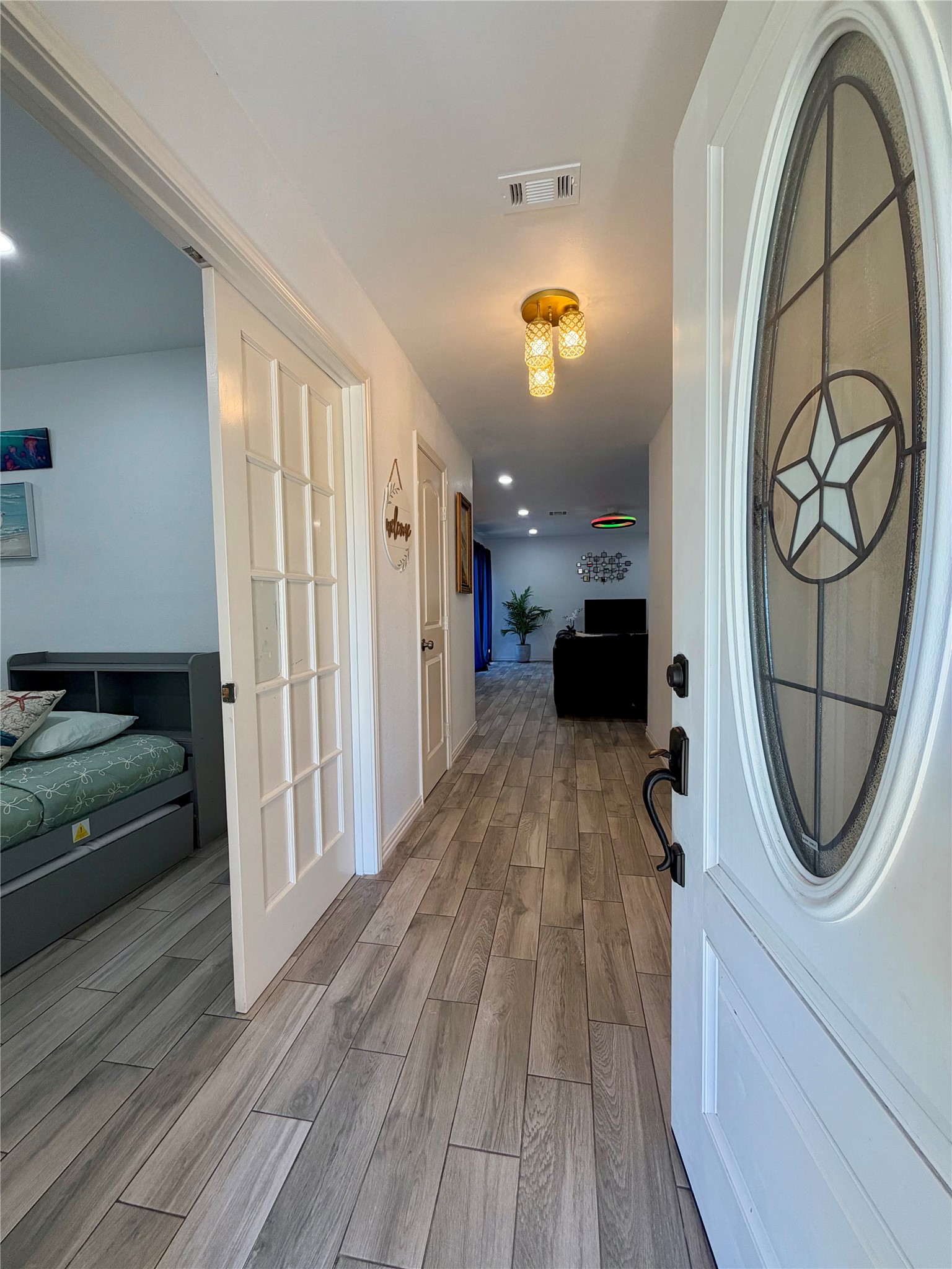Come on in! Spacious entry, bedroom/office space to the left with double French doors, and coat/storage closet.