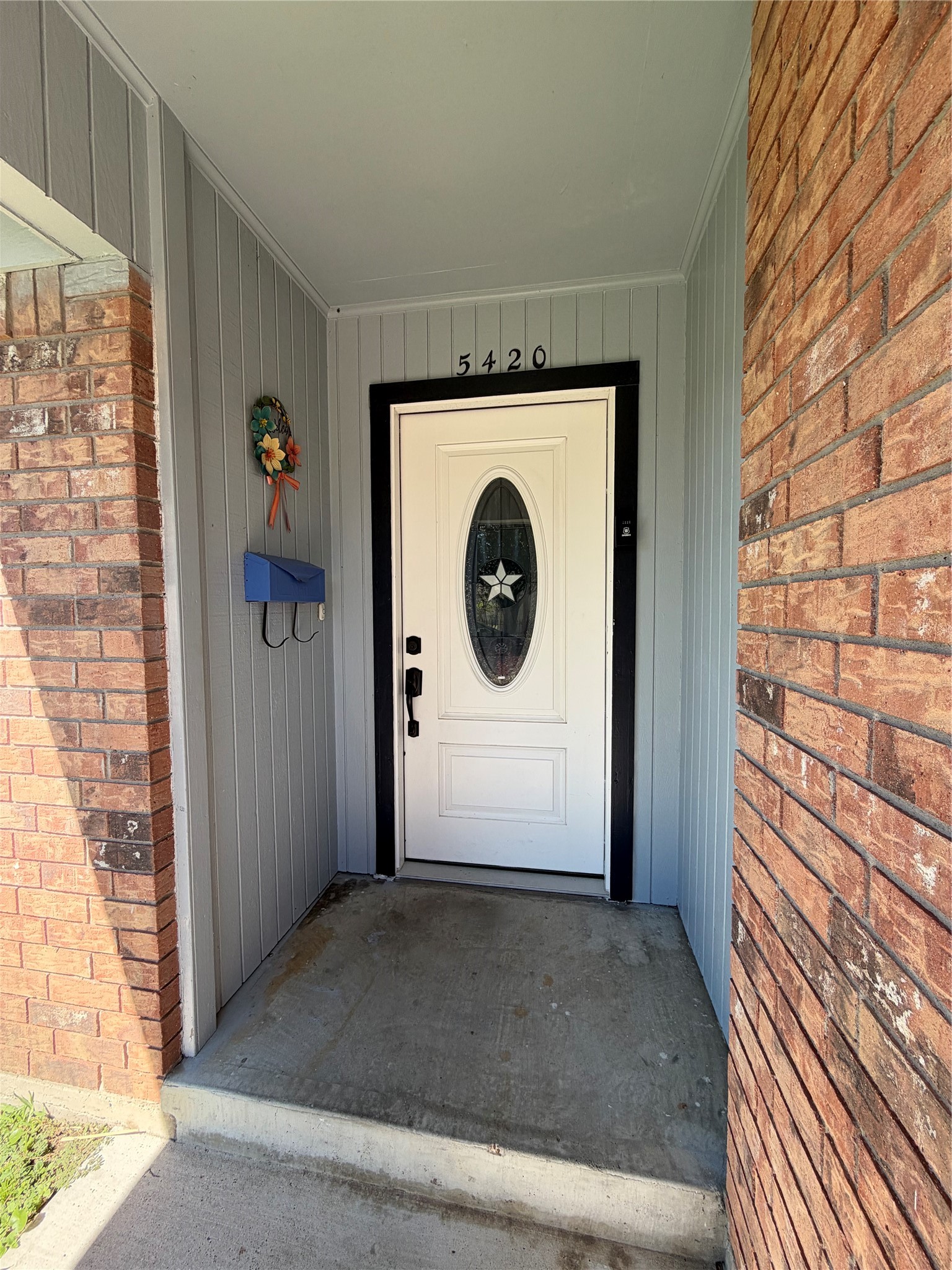 Lovely, covered entry and leaded glass window in front door. Freshly painted in 2025 with newer hardware.