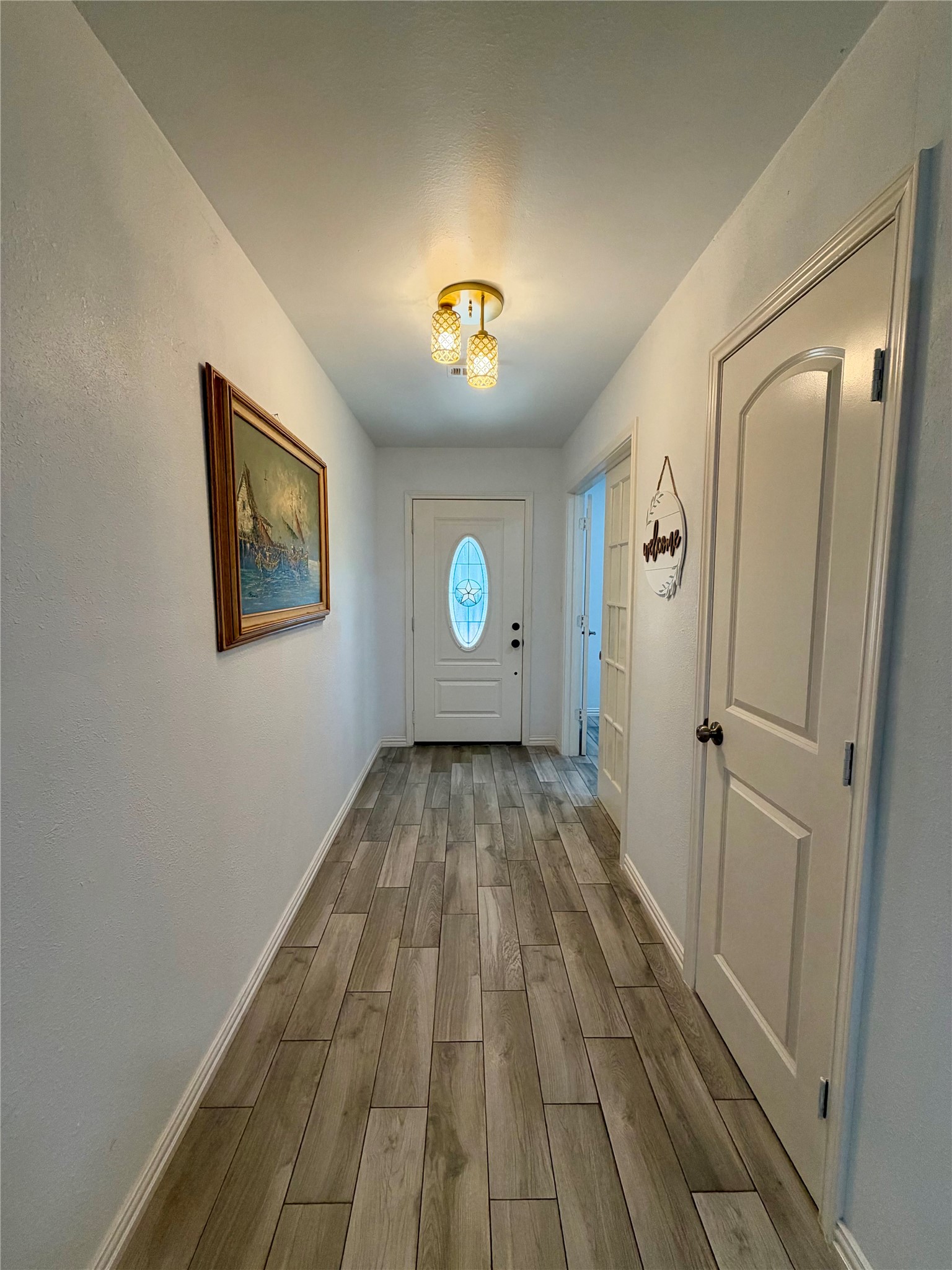 Looking back towards the front door. Roomy coat closet on the right.