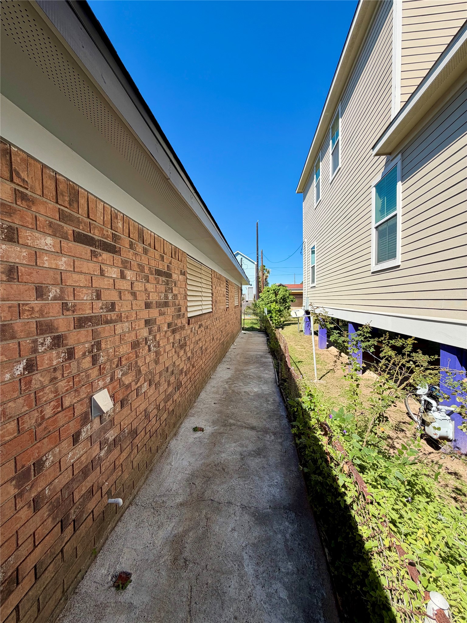 East side of the brick home with convenient, paved walkway